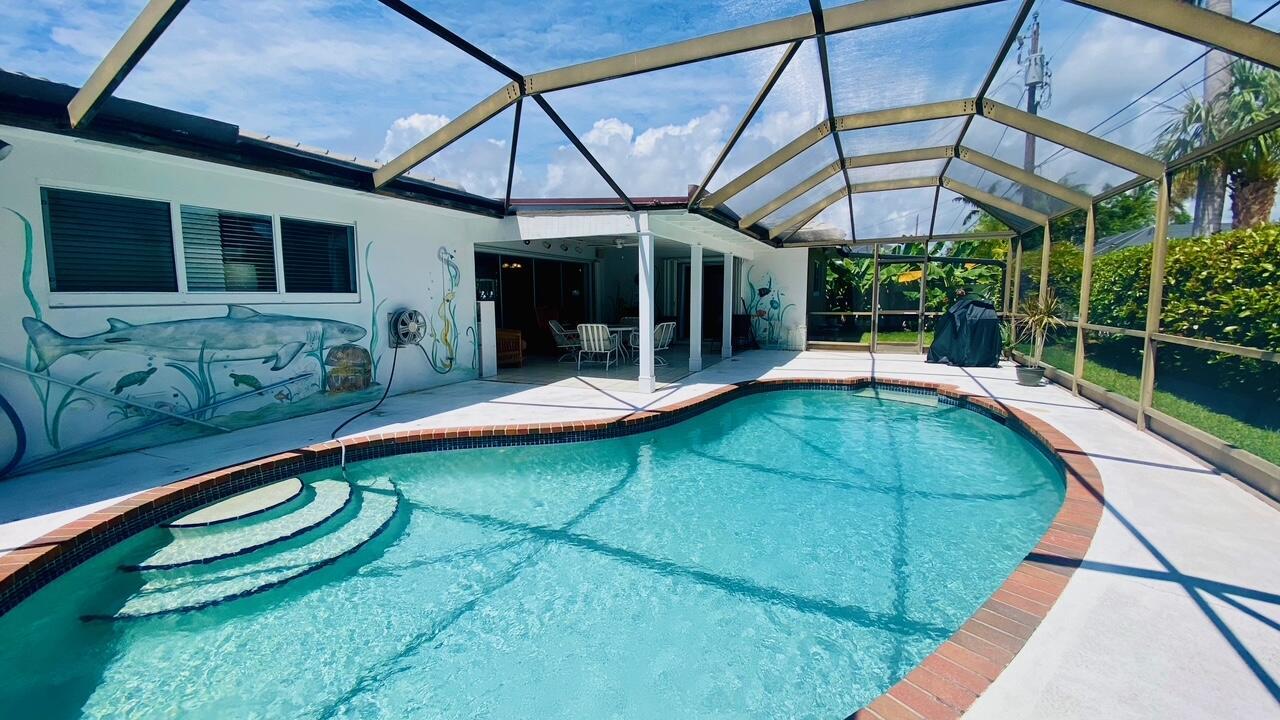 ON SINGER ISLAND where it's simply Paradise. Walk to the beach from this Large Fully Furnished 3 bedroom, 2 bathroom 2 car garage in the inviting Yacht Harbor Manor community of Singer Island. With a total area of 2,695 sqft, This property boasts an open floor-plan, extra-large glass sliders to a large covered patio and POOL. Circular driveway surrounded with privacy and beautiful landscaping.