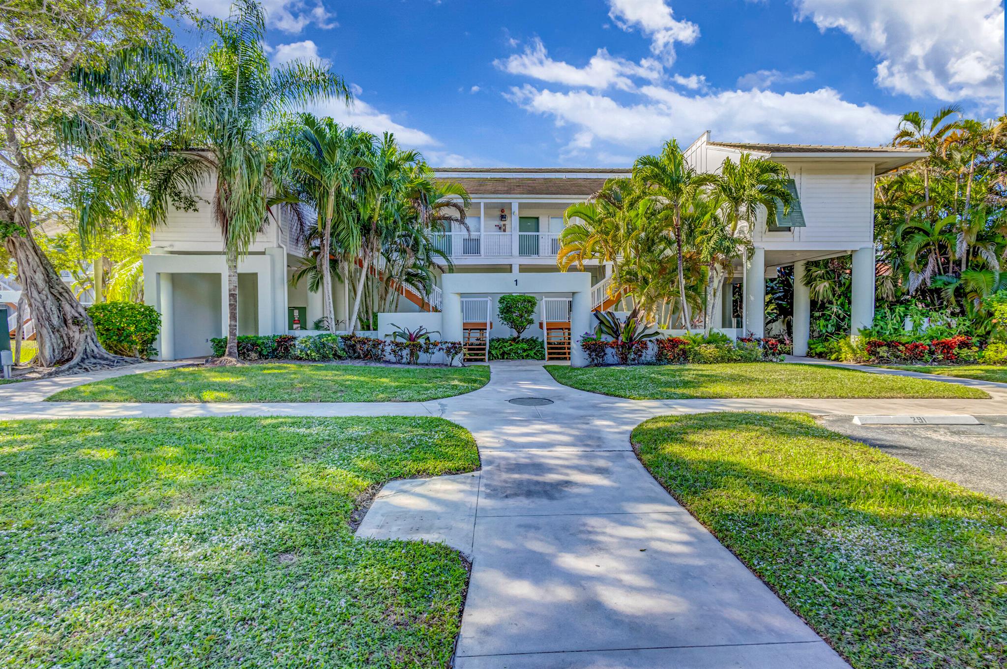 Discover luxury living at its finest in this stunning PGA National residence. Immerse yourself in the epitome of relaxation with rainfall shower heads in updated bathrooms that exude modern elegance. Every detail has been meticulously curated, and the property boasts a seamless blend of style and functionality. Indulge in the convenience of a washer and dryer, while the kitchen showcases a contemporary design with a quartz countertop and a dishwasher for effortless entertaining. Step onto the balcony and be captivated by the waterfront setting, offering spectacular views that elevate everyday living.