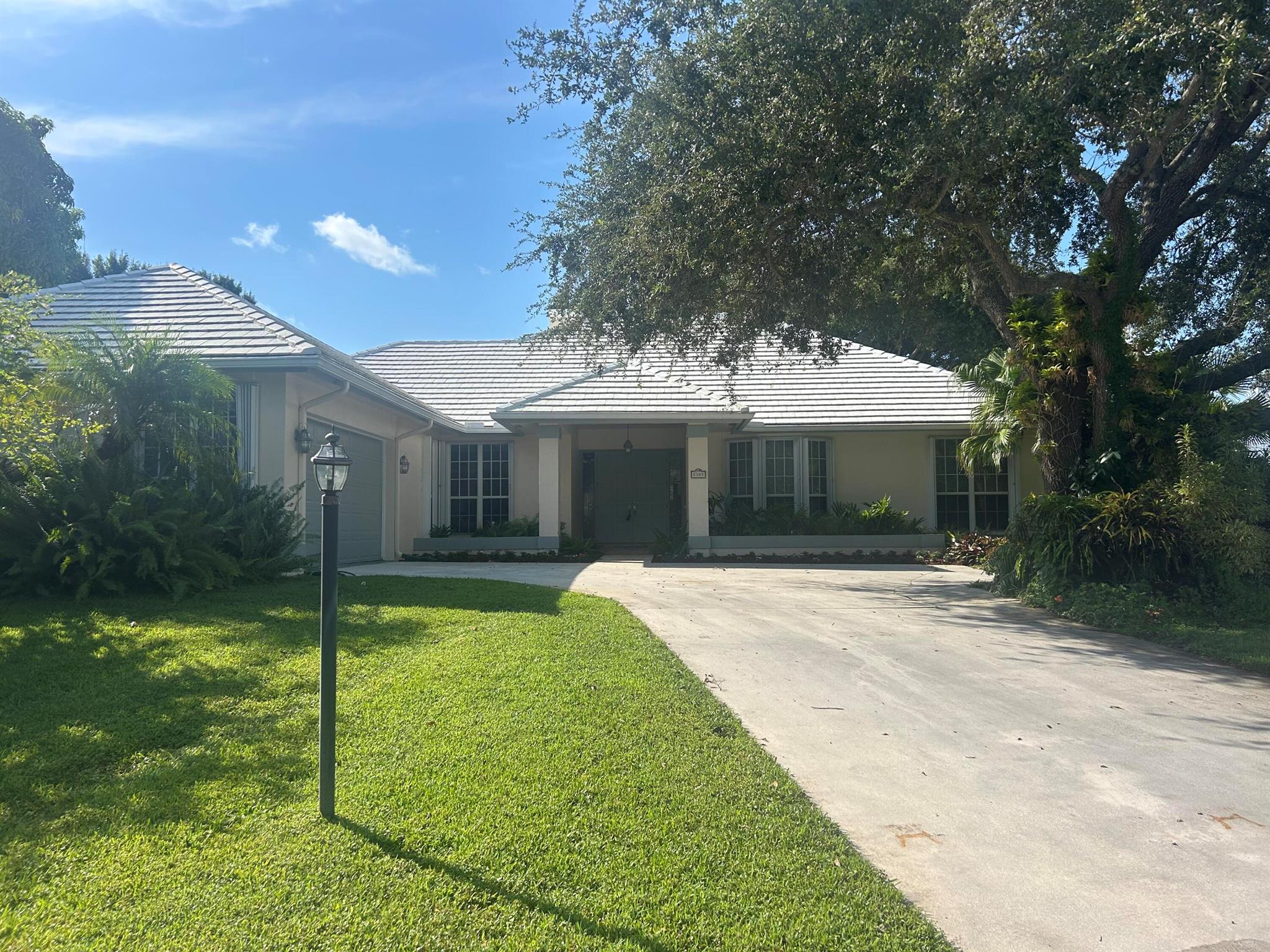 Welcome to this stunning custom built CBS home, nestled in a small, gated community of just 39 all custom residences. The coquina stone fireplace is a true centerpiece that adds warmth and character to the living area.  French doors lead to the under air sunroom - perfect for relaxing and enjoying the quiet solitude of the tropical backyard. This home is also less than 3 miles to beaches, stores and restaurants. Over a 1/4 acre corner lot that has plenty of room for a pool if desired.  New well was just installed for the automatic sprinkler system.  Full house Generac generator.  Gas stove in the chef's kitchen with a large pantry for all of your entertaining. Plenty of storage throughout house and a 3rd garage for a car, motorcycle, small boat or golf cart.