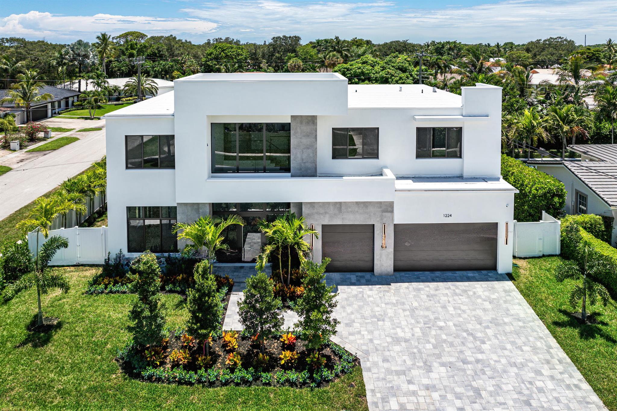 Situated on a prime corner lot in the heart of Boca Square, this stunning new construction home by Regal Pads Development delivers modern design, exceptional functionality, and a location within Boca Raton's top-rated school district--just steps from Addison Mizner Elementary.

A grand 20-foot double-height entry welcomes you into an expansive open floorplan with a seamless flow through the main living areas. The great room features impressive 20.4-foot picture-frame glass sliders that flood the space with natural light and open to a large, lush backyard with plenty of green space, a covered loggia, and a fully equipped outdoor summer kitchen--perfect for entertaining or relaxing outdoors year-round.