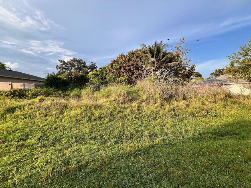 This parcel has nice elevation and plenty of mature fruit trees (mangoes).  Electric, municipal water, sewer and cable available.Great eastern Port St. Lucie location close Martin County.   Check it out today!