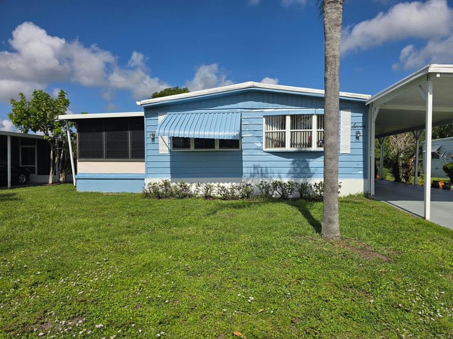 Paradise awaits in this beautifully located home within a vibrant 55+ community!   Sitting on an oversized lot with sweeping views of the private lake, this property offers the perfect blend of comfort, convenience, and Florida serenity. Enjoy an expansive covered carport—large enough for multiple vehicles—plus a spacious storage shed tucked neatly at the back. The home also includes full hurricane shutters for peace of mind during storm season. Residents enjoy access to fantastic community amenities, including a sparkling pool, golf, and tennis. The HOA covers all amenities and the land lease, making living here both easy and affordable.
