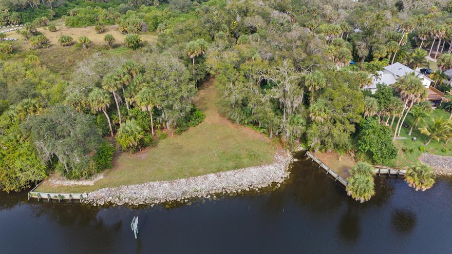 This exceptional and secluded 0.87-acre property boasts approximately 200 feet of waterfrontage on the Okeechobee Waterway, offering breathtaking views of the old Florida landscape beneath a majestic canopy of mature oaks and palms, with access to the Atlantic Ocean. The site features an established canoe launch and seawalls. Located at the end of a road, this private parcel provides unparalleled seclusion and tranquility, making it an ideal canvas for building your dream waterfront residence.