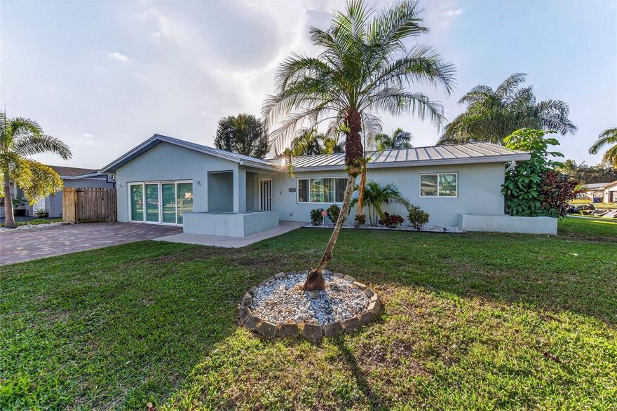 Welcome to your dream home in Palm Aire Village! This beautifully updated 4 bedroom, 2 bath plus office home sits on a huge corner lot and has a bright, open feel with a spacious family room and stylish porcelain tile floors throughout. The kitchen is a total dream with sleek granite countertops, stainless steel appliances, and tons of cabinet space. Step outside to your own backyard paradise, complete with a tiki hut, a great patio, and a saltwater pool, so relaxing and fun! Plus, this home boasts a metal roof, hurricane impact windows & doors and a whole-house generator. You'll love this family-friendly neighborhood, no HOA and central to everything, with easy access to I-95 and the Turnpike. Come see why this is the perfect place to call home.