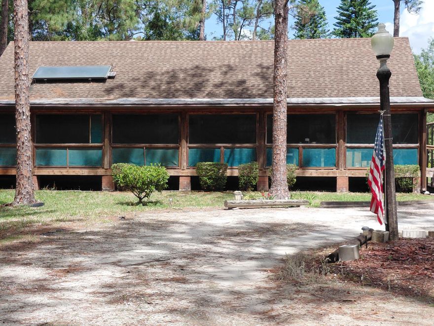 This 2-bedroom, 2-bathroom log cabin offers rustic charm. It is designed with warm wood interiors, open living spaces, and timeless cabin architecture. Located in a convenient and desirable area, the property sits close to shopping, dining, and everyday essentials. For those who love the coast, you're less than 20 miles from the beach, offering access to sun, sand, and waterfront activities whenever the mood strikes. The cabin is nestled among many mature trees, creating a peaceful, private setting with plenty of natural shade and a true connection to nature. Whether you're relaxing on the porch, enjoying the wooded views, or simply appreciating the quiet surroundings, the property offers a serene retreat from the everyday.