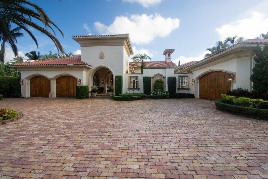 Welcome home to one of the finest country clubs in Delray Beach where you will find this impeccable 5 bedroom, 7.5 bathroom waterfront estate that sits beautifully on one of the most desired, oversized lots in Addison Reserve surrounded by incredible views of the golf course and lake. From the moment you enter the cul de sac and pull into the circular driveway of brick pavers, the charm and grandeur of this 2-story home welcomes you. As you enter the arched passageway of the front courtyard and walk through the front doors, you will be immediately impressed by its vaulted ceilings, marble floors, warm fireplaces, and an open concept floor plan that is light and bright and perfect for entertaining. Tastefully appointed with the finest, top-of-the-line fixtures and features. This home