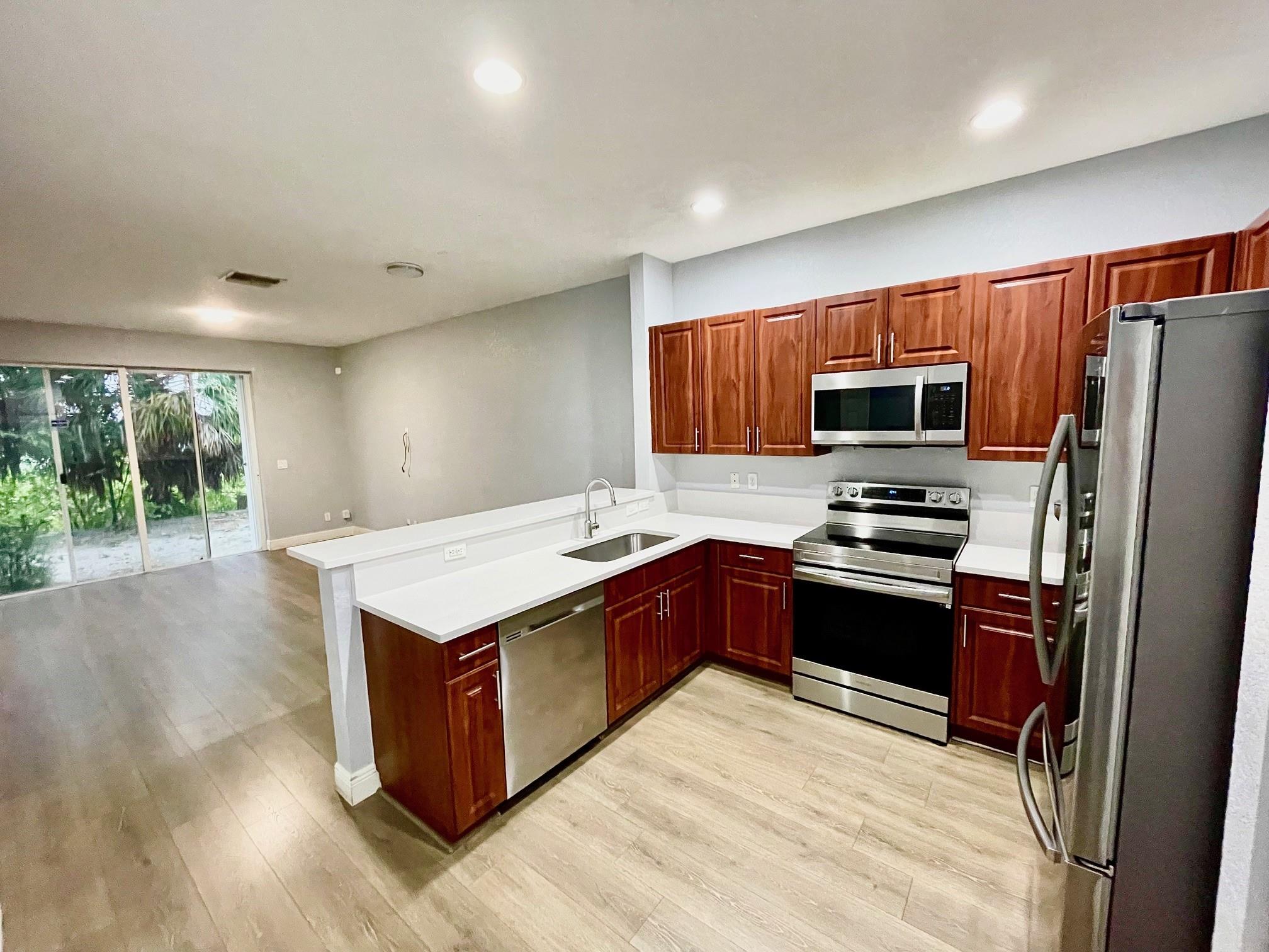 Fully Renovated 2-Story Townhouse in the Gated Georgetown Community-Discover this beautifully renovated and impeccably maintained 3-bed/2.5-bath/Attach. 1-car garage townhouse/perfectly situated in a secure and highly sought-after gated community-Spacious two-story layout w/all 3 bedrooms & 2 full baths upstairs-Stylish laminate flooring throughout-Modern open kitchen w/high-end cabinetry, granite countertops, and stainless-steel appliances-Central A/C (ice cold!) Private driveway w/parking for two vehicles-Professionally managed with regular security patrols for added peace of mind-Resort-style amenities: sparkling pool, basketball court, cabana, and playground-Pet friendly community-Located near the Turnpike, I-595, and I-95, offering easy access to shopping, dining, and entertainment.