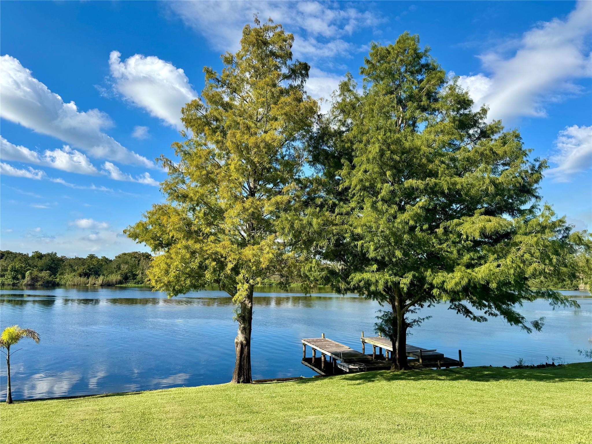 Experience riverfront living on nearly 1 acre of beautifully landscaped property with mature oaks. This  3-bedroom, 2.5-bath home features a metal roof, newer Kinetico water system, and a large screened porch. Inside, you’ll find a generous layout with a living room, den, dining room, and breakfast nook — offering plenty of space! The kitchen and bathrooms provide abundant storage with extra cabinetry. The large master suite includes a relaxing garden tub and separate shower. Step outside to a separate screened entertaining building with amazing waterfront views. The property also features two storage buildings and a fully fenced yard with an automatic gate. A private boat dock allows easy access to the Kissimmee River. The home comes partially furnished and is move-in ready!