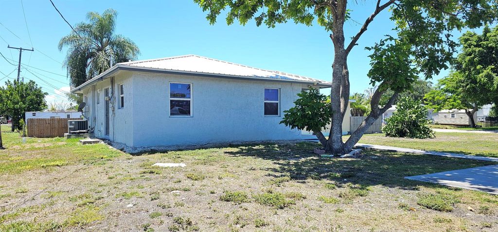 Photo of 716 NW 16th Street, Belle Glade, FL 33430 (MLS # R11099076)