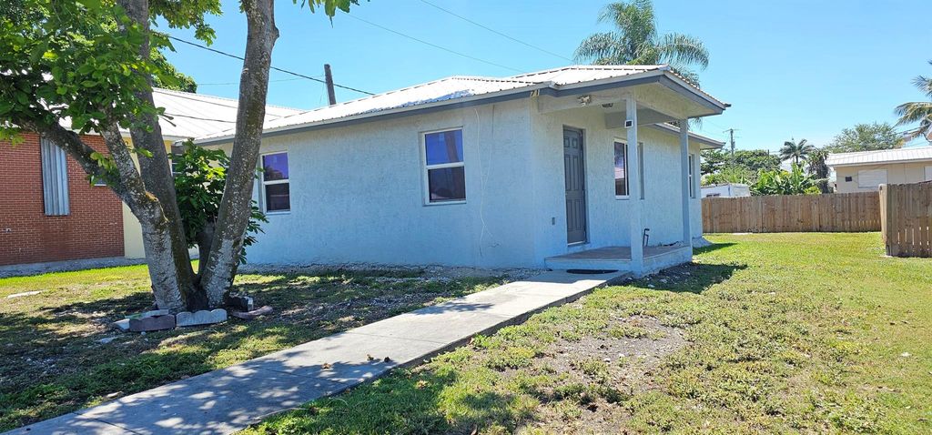 Photo of 716 NW 16th Street, Belle Glade, FL 33430 (MLS # R11099076)