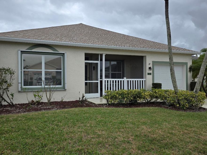 Located in the very active 55+ community of Kings Isle in St Lucie West, is this immaculate CBS home in move-in condition. Roof was replaced in 2023. Outside was also painted in 2023. This home features 2 bedrooms with 2 bathrooms overlooking a lake from the screen/glass window patio. A triple sliding door leads to a kitchen that has lots of counterspace with wood cabinets topped with crown molding.  Most windows have plantation shutters. Electronic air filter in the A/C system. Easy closing accordion shutters on all windows for storm protection. Lots of cabinets in the garage along with pulldown stairs. Don't miss this one.