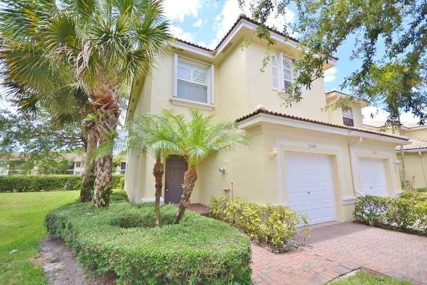 Fully furnished turnkey townhome in the heart of Wellington in sought after Georgian Courts.  Live the Florida lifestyle in a wonderful Wellington community or purchase as an investment and rent it seasonally or annually! Large 2 BR, 2.5 BA,. plus a loft (or third bedroom)  corner unit on the canal...located in the back of the subdivision with single car garage and long paver driveway which would accommodate 3 vehicles.  Additional parking available. Low HOA which includes lawn care, maintenance of the exterior and community pool. Step inside to an open living/room dining and fully stocked kitchen with upgraded wood kitchen cabinetry, pantry with pullouts, granite counters. 1/2 bath downstairs.  Glass sliding door leads to the backyard with paver patio which backs to a canal...
