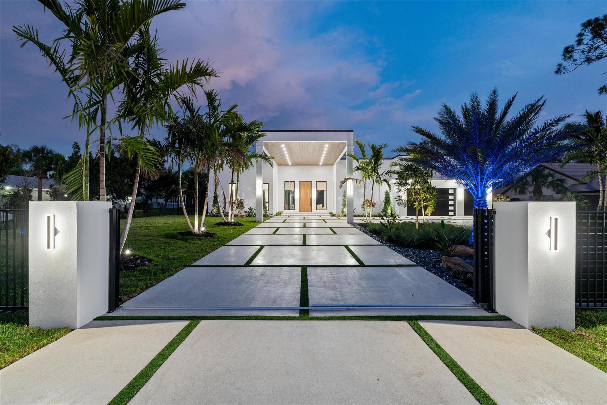 Modern Luxury New Construction. This 7-bed, 8.5-bath estate spans nearly 7,000 sq. ft. with soaring 16' ceilings and sleek European cabinetry throughout. The chef’s kitchen boasts Wolf appliances, an oversized island, Taj Mahal Quartzite, and a built-in breakfast extension. Porcelain tile flows through the open-concept layout, connecting a theater/media room, home gym, and private guest house. A 500-gallon propane tank powers a whole-house generator. Accordion-style impact sliders create seamless indoor/outdoor living with two pickleball courts, full summer kitchen, and spacious lounge areas.