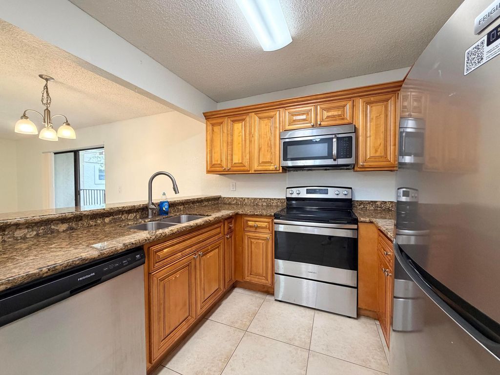 Photo of 1541 Windorah Way #E, West Palm Beach, FL 33411 (MLS # B26044999)