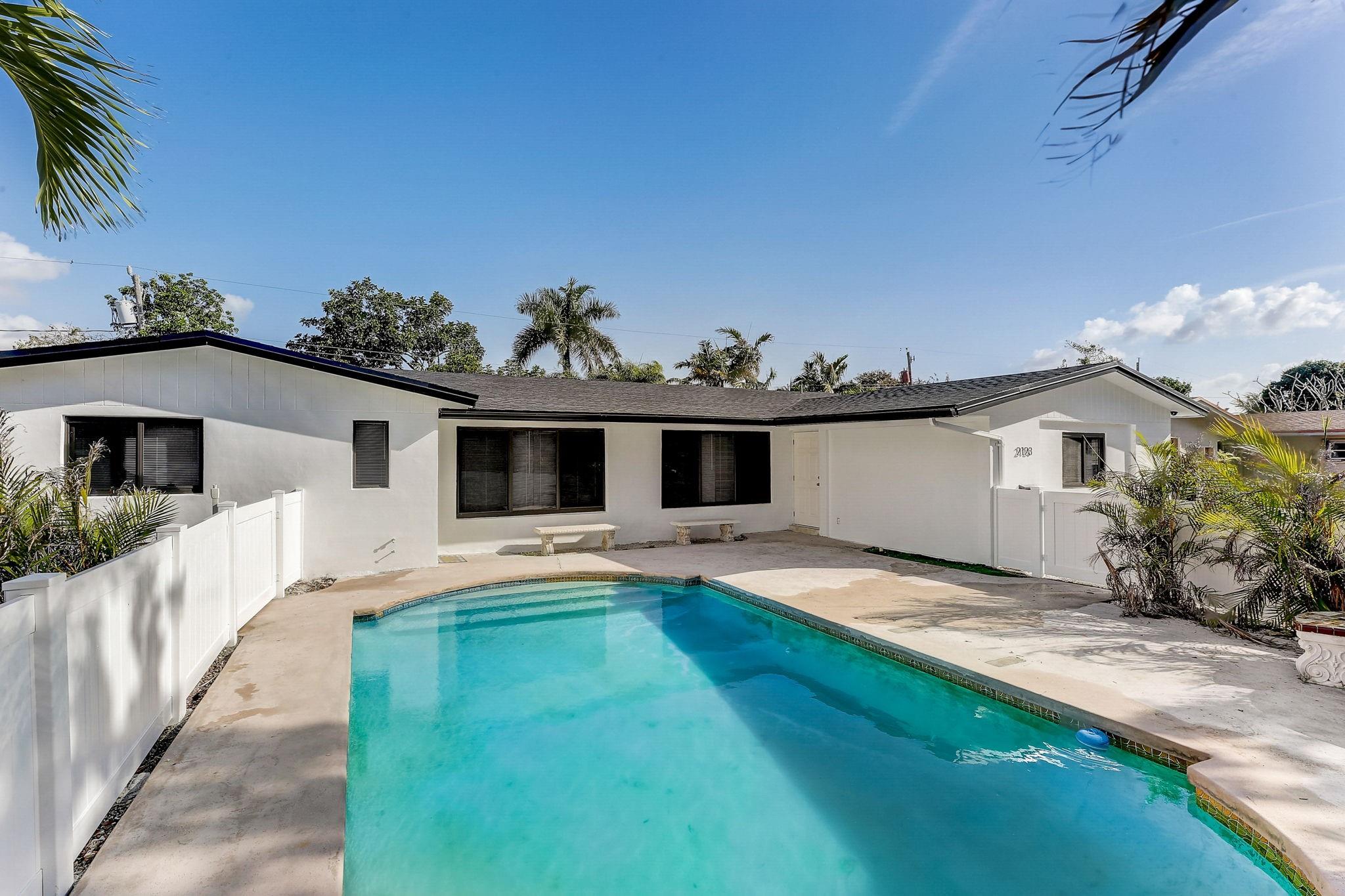 Short Term Rental Furnished Large and spacious 2 bedroom unit in a resort-style Triplex in East Fort Lauderdale! Fully renovated property with brand new roof, impact windows, Kitchen and bathroom with a private pool nestled amidst lush tropical landscaping, offering residents a luxurious retreat. newly repaved driveways - Great Location