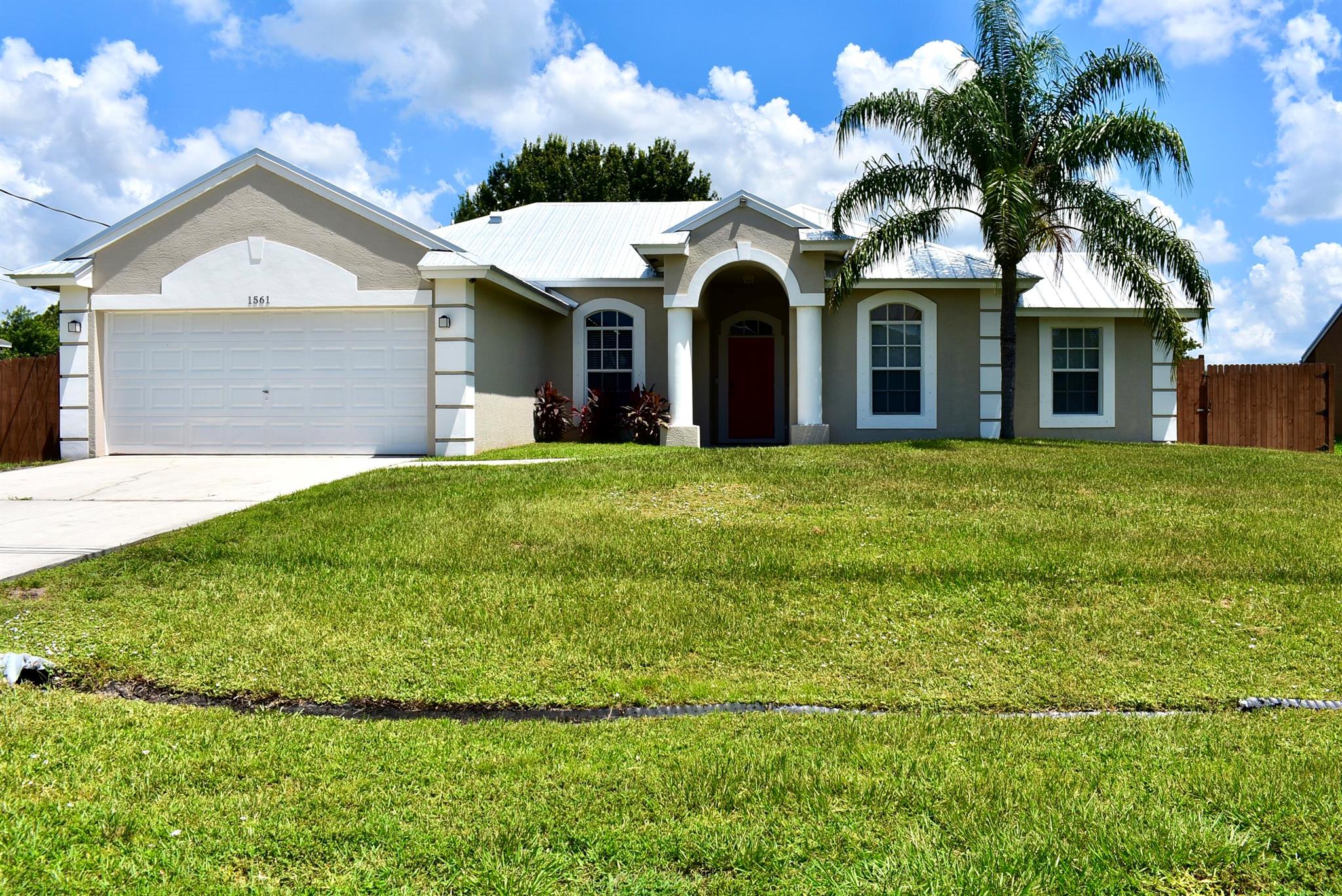 Beautiful CBS home with a multigenerational layout--perfect for guests, in-laws, or flexible living needs! Features 3 bedrooms, 2 bathrooms, a spacious kitchen with eat-in area, open floorplan, laundry room, and laminate & tile flooring throughout--no carpet! Enjoy a large fenced-in backyard, ideal for pets or entertaining. The primary suite offers a walk-in closet, soaking tub, and a floor-to-ceiling tiled shower. 2-car garage, all appliances included, and furniture conveys (excluding select personal items). Recent updates: metal roof (May 2025) and fresh exterior paint. Prime location near I-95, top-rated schools, and shopping. Move-in ready and full of value!