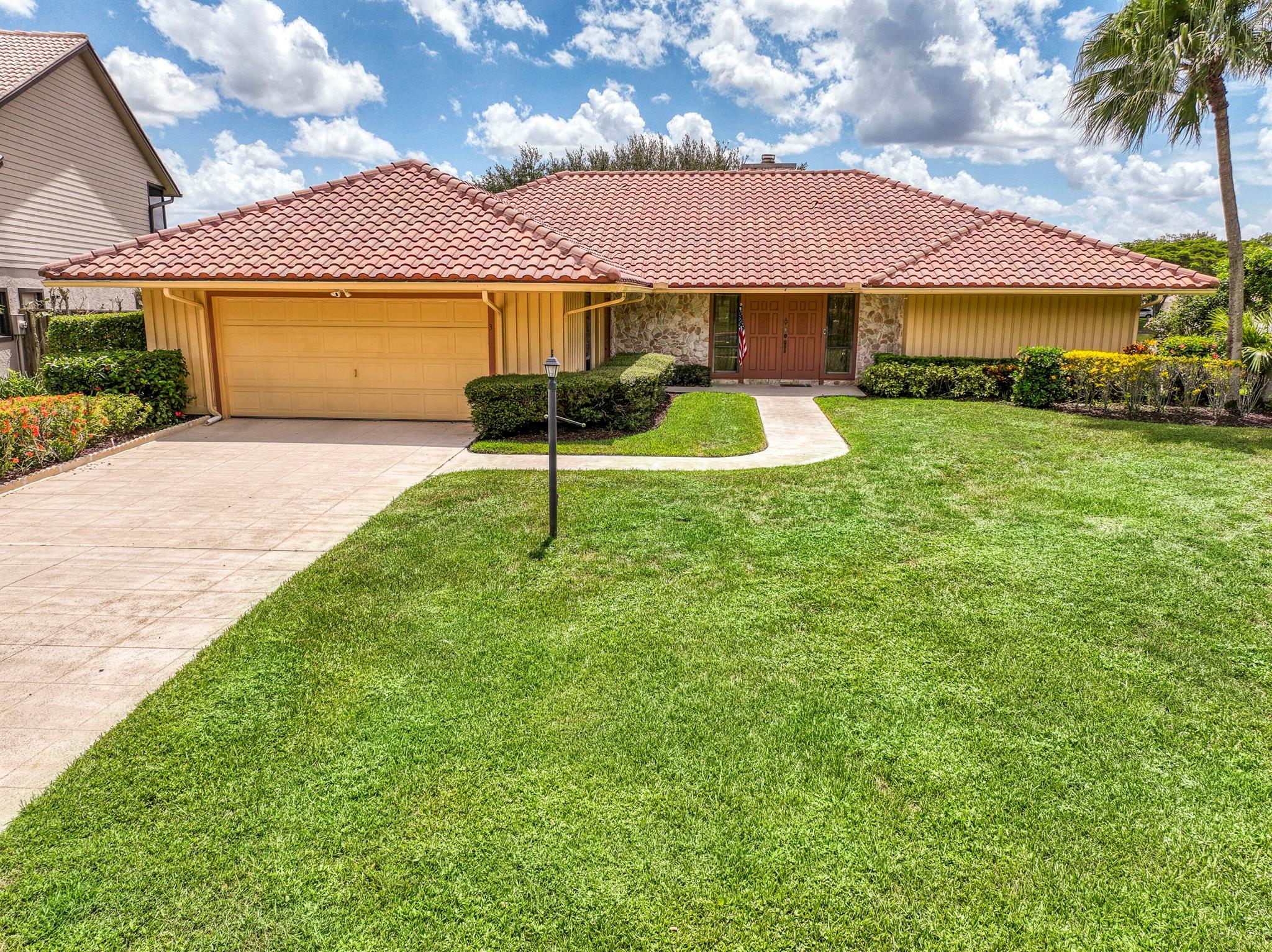 Discover sweeping golf course and lake views at this serene retreat tucked away on a quiet cul-de-sac in the sought-after Glengary community at PGA National. Perfectly situated on the Fazio Golf Course with direct views of the lake, fountain, and PGA National Resort, this 3BR, 2BA pool home captures the essence of Florida living. Step inside to a bright, open great room with shiplap walls, a cozy wood-burning fireplace, and a wet bar -- all framed by expansive windows showcasing the stunning outdoor views. The split floor plan provides privacy, with the primary suite featuring dual walk-in closets, sliders to the pool, and a spacious bath with a soaking tub, walk-in shower, and dual vanities. The screened-in pool and lanai are the heart of this home, offering plenty of covered outdoor