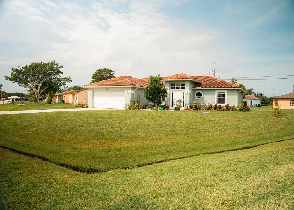 Photo of 2474 SE Rock Springs Drive, Port St Lucie, FL 34952 (MLS # R10898989)