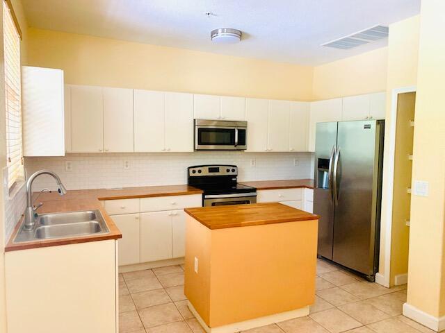 Spacious 3 bedroom 3.5 bath, 3 story townhome in highly desirable Gated SHOMA. Ground floor offers 1 bed with wood look laminate floors, 1 full bath, 1 car garage, laundry. Light, bright second floor kitchen, with white cabinets, butcher block counter tops, stainless appliances, dining room, living room and half bath with tile floors, open floor plan and Balcony. The third floors offers 2 bedrooms, 2 baths, new laminate wood floors, and freshly painted. A/C, washer and dryer 5 years old! New water heater. Located close to Pool/Clubhouse with exercise room. Community is close to shopping, local venues and convenient to turnpike and I95 Great schools district! Includes 1 car garage and 1 parking space on the driveway.