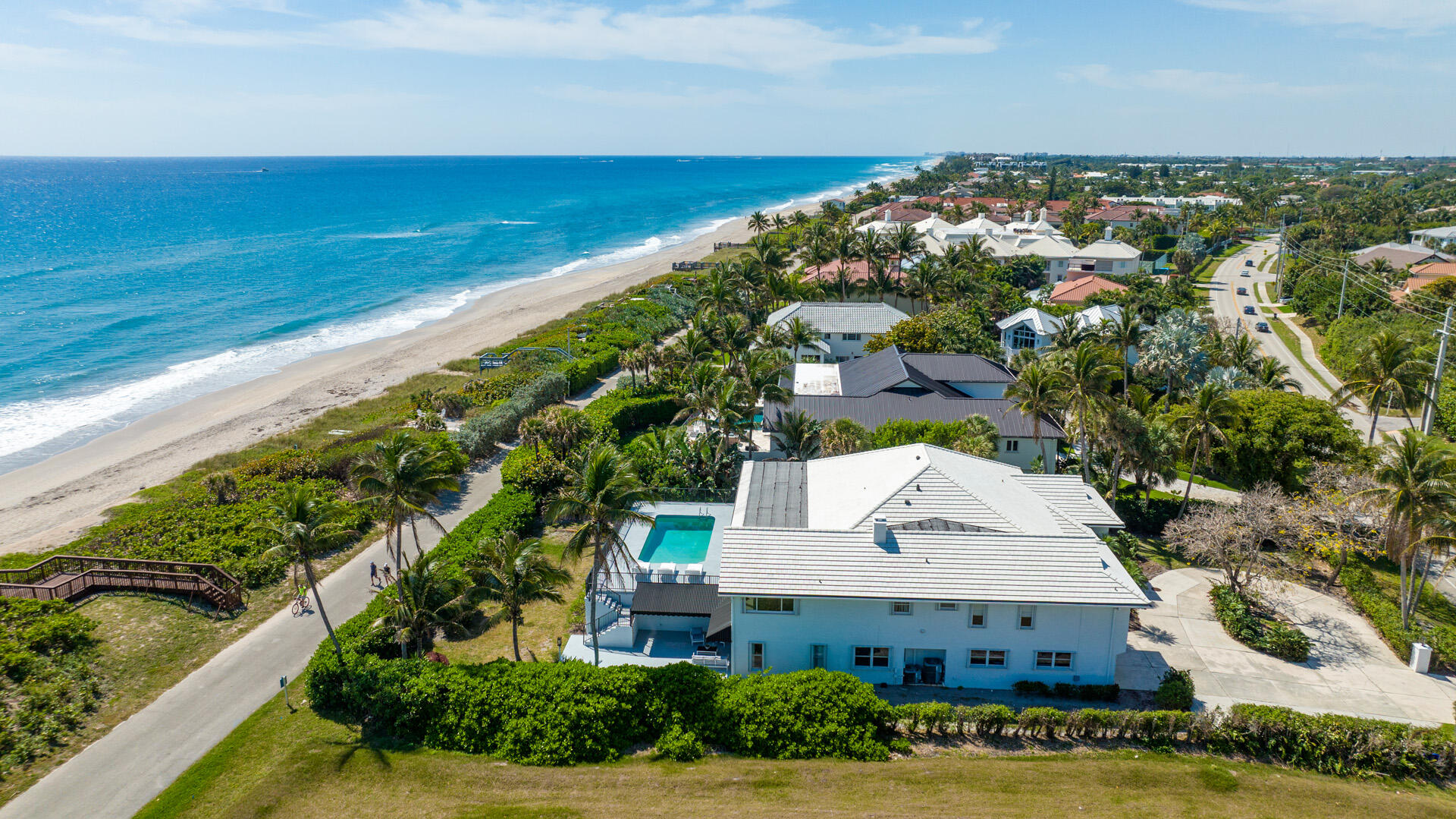 Chic oceanfront 'Beach House' estate, with a contemporary vibe, offers the ultimate beach lifestyle with all major rooms opening to the ocean-view loggia, pool and pool deck. On the main floor, a split-bedroom plan affords privacy, and for hosting guests or for family living, the entire lower floor layout includes additional guest bedrooms, gym, yoga room, kitchen, an entertainment room and more. The information herein is deemed reliable and subject to errors, omissions or changes without notice. The information has been derived from architectural plans or county records. Buyer should verify all measurements.