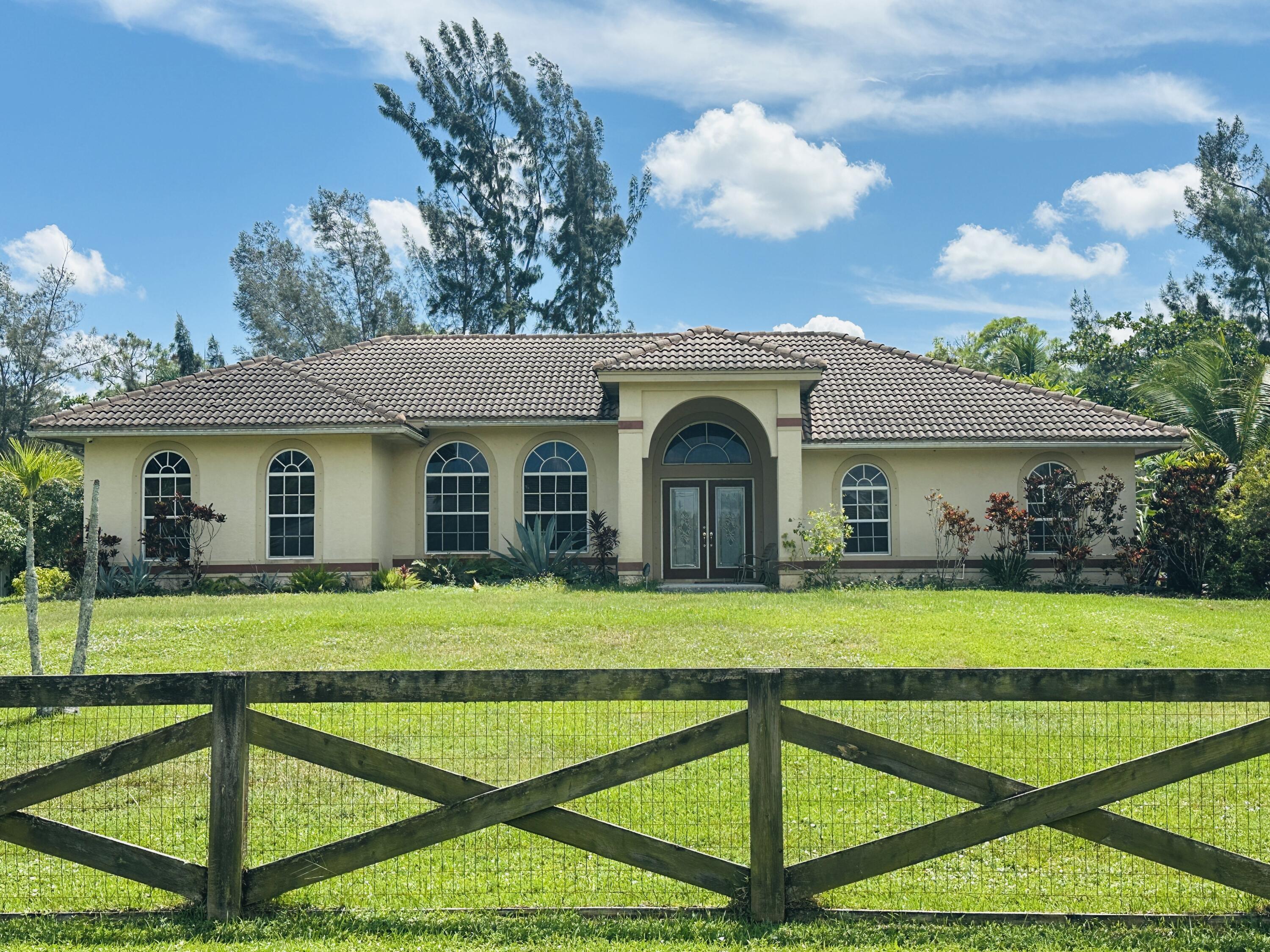 **SHOWINGS BEGIN - MONDAY, 9/15/25Spacious 5-bedroom, 3-bath pool home on 1.29 acres in The Acreage! This home features a split floor plan, carefully planned living areas, and an updated kitchen. The private primary suite offers a double shower and jacuzzi tub. Extended laundry room and bedrooms!Enjoy the screened-in pool and extended patio, perfect for relaxing or entertaining. NO HOA!!! Bring your Pets, Trucks, Boats, RV!Conveniently located near the new Avenir Town Center, shopping, dining, parks, and top-rated schools. Water and lawn care are included for stress-free living.