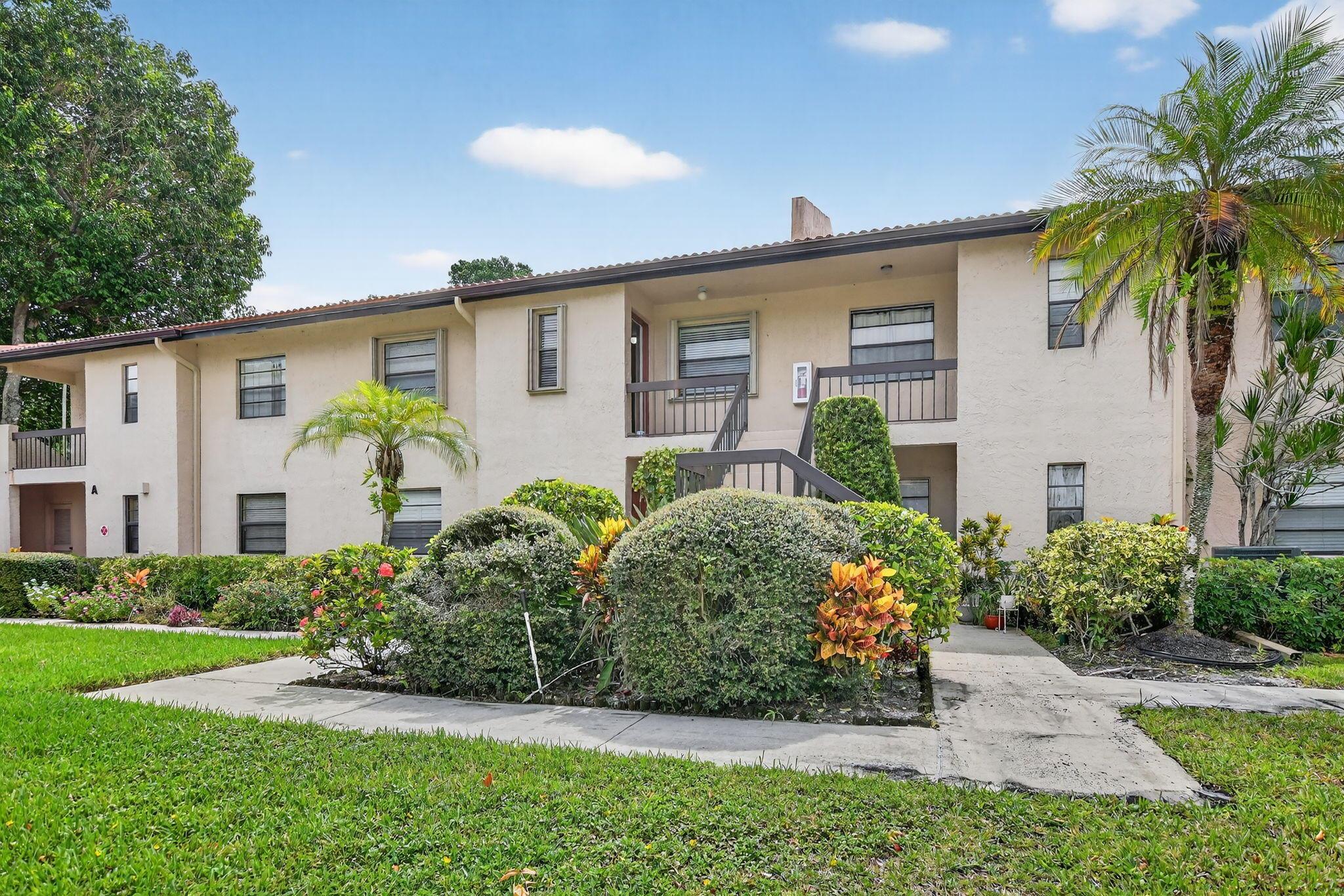 This beautifully renovated unit offers the perfect blend of style, comfort, and natural serenity. Step into a spacious living area with smooth ceilings and elegant laminate flooring that flows seamlessly through the common spaces. The Florida room adds valuable extra square footage -- ideal for a home office, reading nook, or sunlit lounge. The kitchen has been thoughtfully opened up to enhance flow and functionality featuring sleek quartz countertops, stainless steel appliances, and newer cabinetry and flooring. From the kitchen and one of the bedrooms, enjoy calming garden views. Both bedrooms are newly carpeted for comfort. The community boasts two sparkling pools, vibrant social areas, and a full calendar of activities. Just outside the entrance, you'll find one of Boca Raton's most