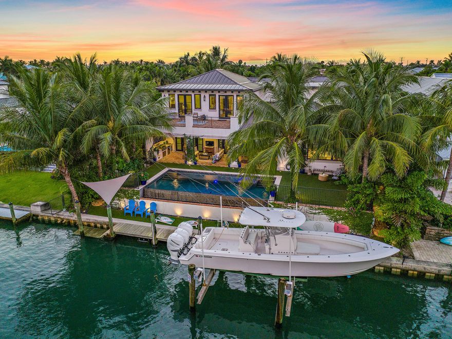 This custom built waterfront home (2017) is nestled in Waterway Village, one of Jupiter's most sought after Bluewater communities. A rare find just less than 1 mile from the Jupiter inlet with no fixed bridges and turquoise blue water at all tide levels.  In the backyard you'll enjoy a true Florida life style as the lot has 90 ft of water-frontage and a dock with a 20k lb boat lift. A large covered deck with outdoor kitchen is perfect for entertaining and looks out on the custom built heated salt water pool. Inside the home you'll find hardwood floors throughout, a beautiful custom kitchen with large island, Thermador gas range, and views of the water. A ''hidden'' den is tucked behind a painting just off of the living room. Waterway Village has a low HOA with little restrictions and a private waterfront park with day dock accessible with a key fob. Conveniently located by local boutiques and popular restaurants.