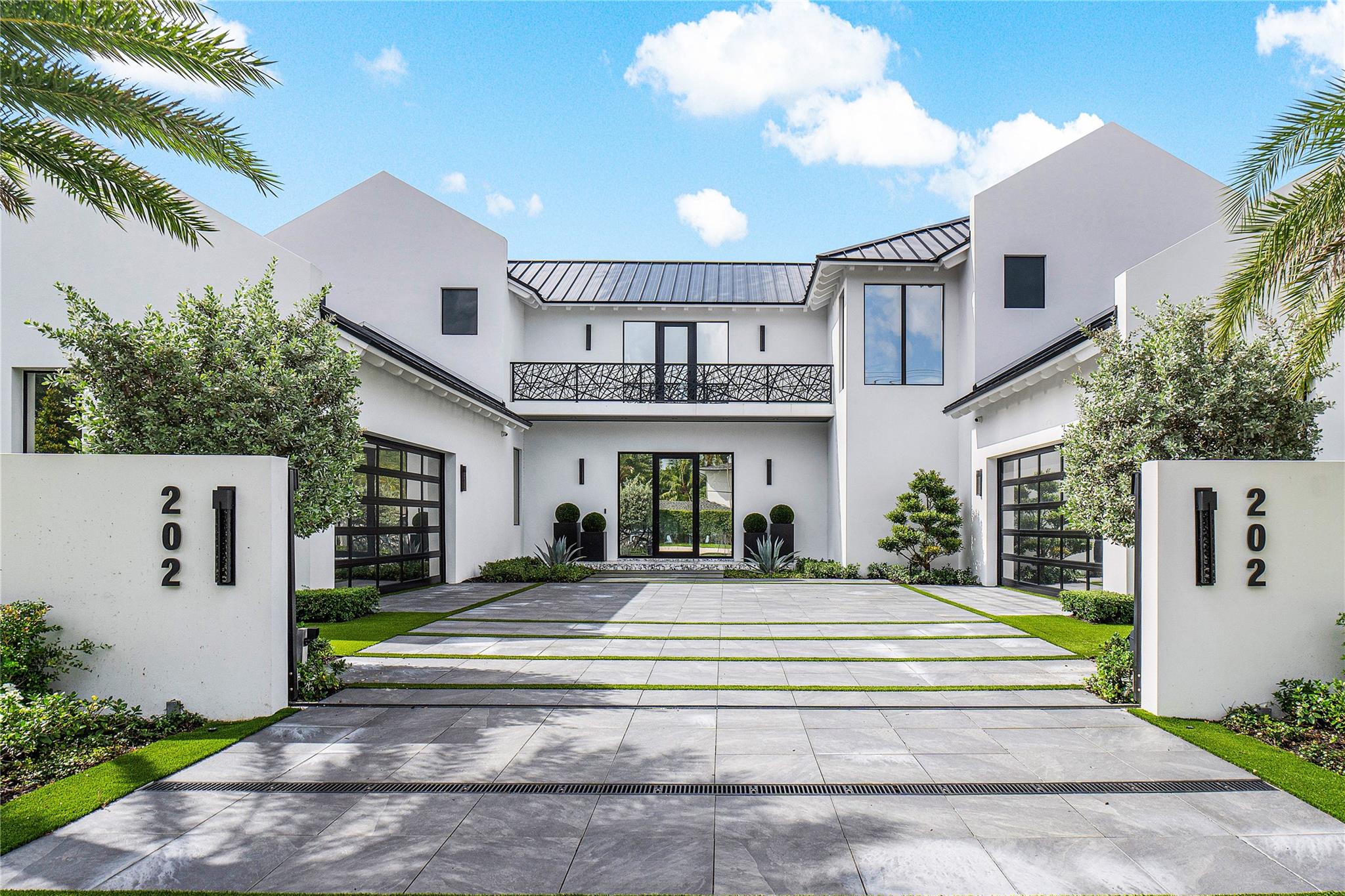 This brand-new, meticulously designed residence built by Azure Development blends sophisticated design, custom details, and superior craftsmanship in the heart of Delray Beach’s coveted Lake Ida neighborhood. Crafted for seamless indoor-outdoor living, the home features five spacious bedrooms and an open-concept layout filled with natural light. Inside, soaring ceilings with European white oak floors, and bespoke finishes. The Eggersmann kitchen is a culinary showpiece with Miele appliances and a custom German marble island with a black oak dining table. The primary suite offers a private sanctuary with a balcony, steam shower, and Italian porcelain finishes. Outside, the landscaped backyard features a sunken firepit, covered loggia, and sleek LED pool, creating a private oasis of luxury.