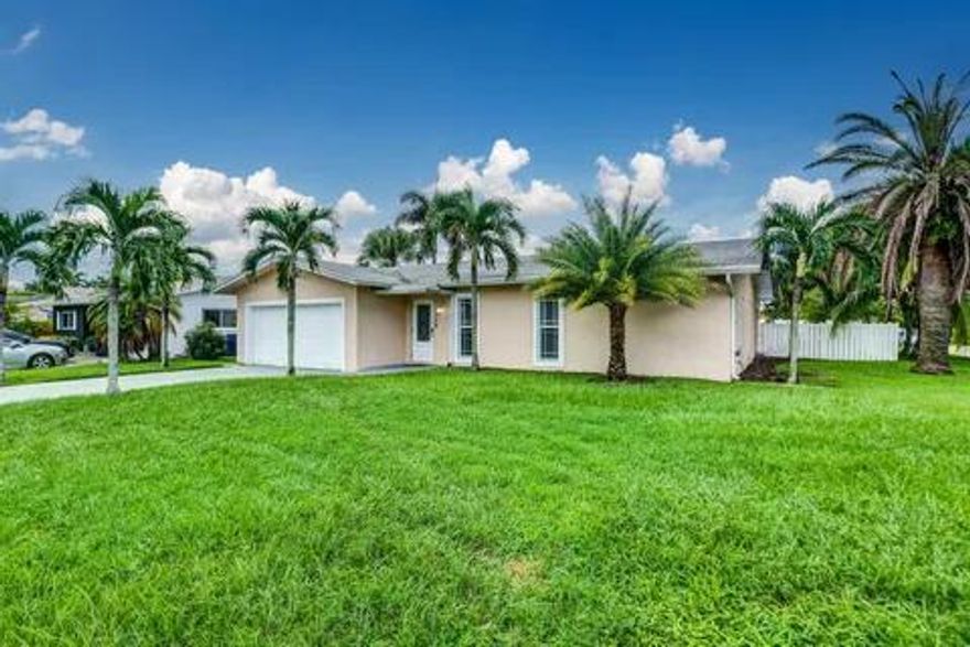 This spectacular, fully furnished home offers 4 spacious bedrooms and 2 beautifully updated bathrooms. Featuring new impact-resistant windows and doors, this property provides both comfort and peace of mind. The remodeled open-concept kitchen is a true highlight, overlooking both the living and family rooms—perfect for entertaining. It boasts stainless steel appliances, recessed lighting, and modern finishes throughout. Enjoy generously sized bedrooms, updated bathrooms, and plenty of natural light. Step outside to a large private pool and a beautifully landscaped yard, ideal for relaxing or hosting guests. The home also includes a 2-car garage and sits on an oversized corner lot with a privacy fence. Located in a quiet and private neighborhood.