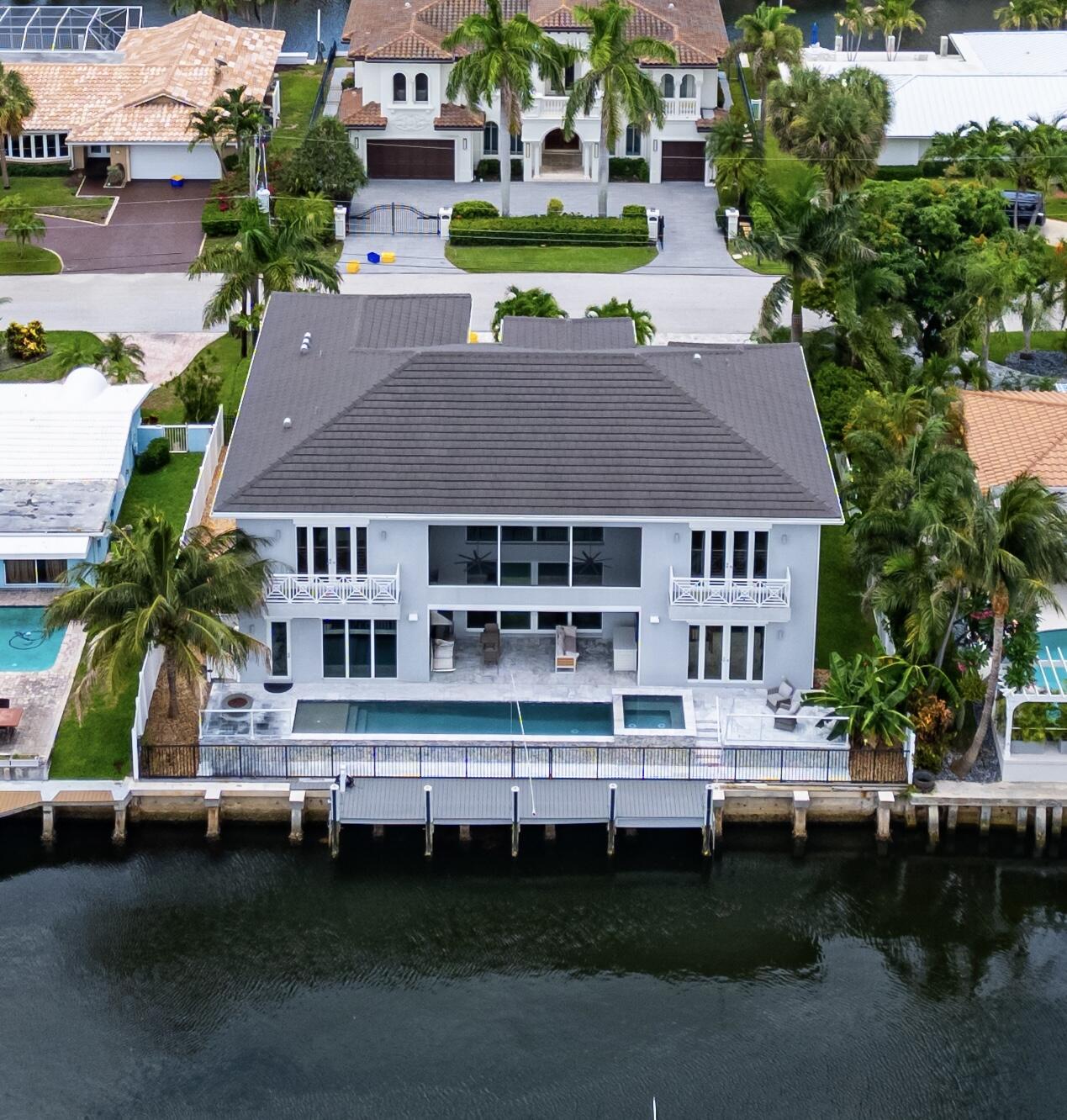 807 Dover Street, a 2021 custom built in Boca Raton's exclusive Bel Marra on 85+/- feet of waterfrontage, and direct ocean access with no fixed bridges, which offers a seamless blend of contemporary and classic design.Inside, high ceilings and premium finishes define the open, light-filled spaces. The chef's kitchen features high-end appliances with natural gas and is complemented by a dedicated wine room.The primary suite, located on the main level, overlooks the waterfront. A private elevator accesses the second floor, which includes a VIP suite and three additional guest rooms.Outside, sliding glass doors open up to the lanai with a remote phantom screen feature and summer kitchen. The property boasts a resort-style pool and spa.