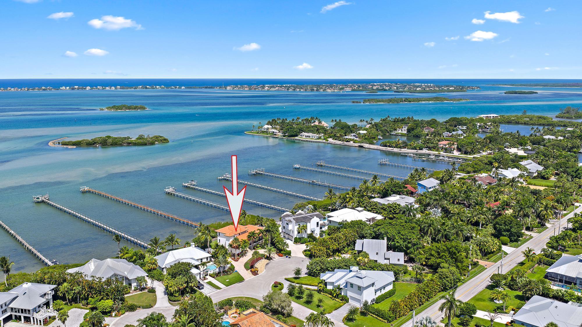 Located on the southern end of Sewall's Point, 14 Herons Nest is a striking waterfront residence offering panoramic views of the Indian River and a front-row seat to some of the most breathtaking sunrises on the Treasure Coast. Solidly constructed of poured concrete and fully equipped with impact glass for storm protection, this home combines enduring quality with effortless coastal elegance.Inside, you'll find a chef's kitchen with custom hardwood cabinetry, granite countertops, and stainless steel appliances--ideal for both quiet mornings and lively gatherings. Travertine and wood flooring flow throughout the home, adding warmth and texture. The sprawling backyard is designed for relaxation and
