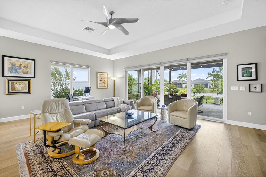 Welcome to this elegant 3 bedroom, 3 bath residence nestled in one of the areas most desirable active adult community of Valencia Sound. Thoughtfully designed for comfort, convenience and style, this home offers a perfect blend of sophistication and low maintenance living. Step inside to find an open concept layout with volume ceilings, sun filled living spaces and high end finishes. The gourmet kitchen features upgraded cabinets, counter tops and stainless steel appliance.  The oversize kitchen island is ideal for entertaining or creating a cooking masterpiece. The ensuite guest area is ideal for short stay or long stay guests. Enjoy year round relaxation in the expanded outdoor living space complete with picture screen viewing screen enclosure.