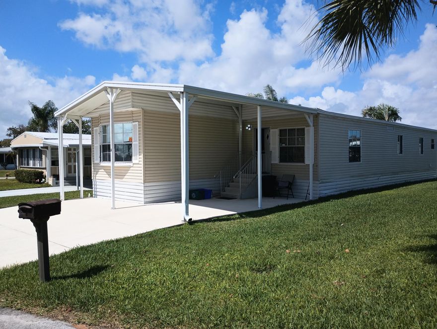 Welcome to this beautifully maintained modern looking home in the desirable Spanish Lakes Riverfront Community( RV Boat storage may be available). This spacious residence offers an open, light-filled layout with a comfortable living area, a well-appointed kitchen, and generously sized bedrooms for easy Florida living (Stacked bedrooms). Enjoy morning coffee or evening relaxation on the refurbished Deck, adding valuable extra space year-round. The home features updated flooring, a convenient carport, and an attached storage/laundry area. Located on a quiet street just steps from community amenities, including pools, clubhouse, tennis, and golf. This move-in-ready home is perfect for full-time or seasonal living in a vibrant 55+ lifestyle community. Lot rent/HOA  for$833.06 A month