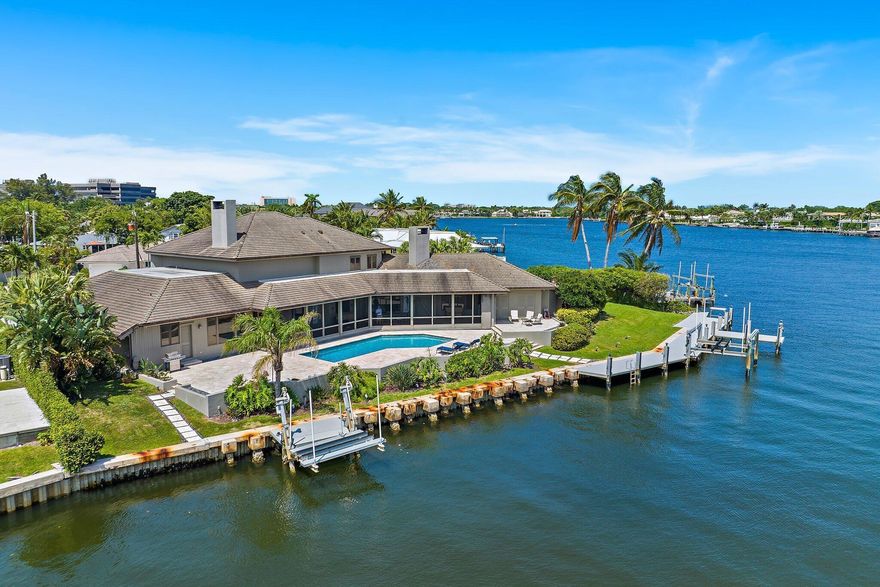 Rare opportunity offering 200' of deepwater frontage on one of North Palm Beach's most scenic lots!  This cul de sac home is located in HIDDEN KEY, a coveted private enclave East of US 1.   Custom built to feature organic design elements including true hardwood floors, plantation shutters, solid wood doors + pocket doors  Concrete Roof was replaced in 2011. Enjoy serene + secure living on Little Lake Worth (w/ easy Ocea n access). You can fish off your private dock! Water views from all main living areas. All bedrooms offer ensuite baths. Residents of North Palm Beach enjoy a newly renovated public country club w/ signature Jack Nicklaus golf, Olympic sized pool, fabulous tennis + wonderful indoor/outdoor dining overlooking the golf course. This home is just minutes to the best beaches,