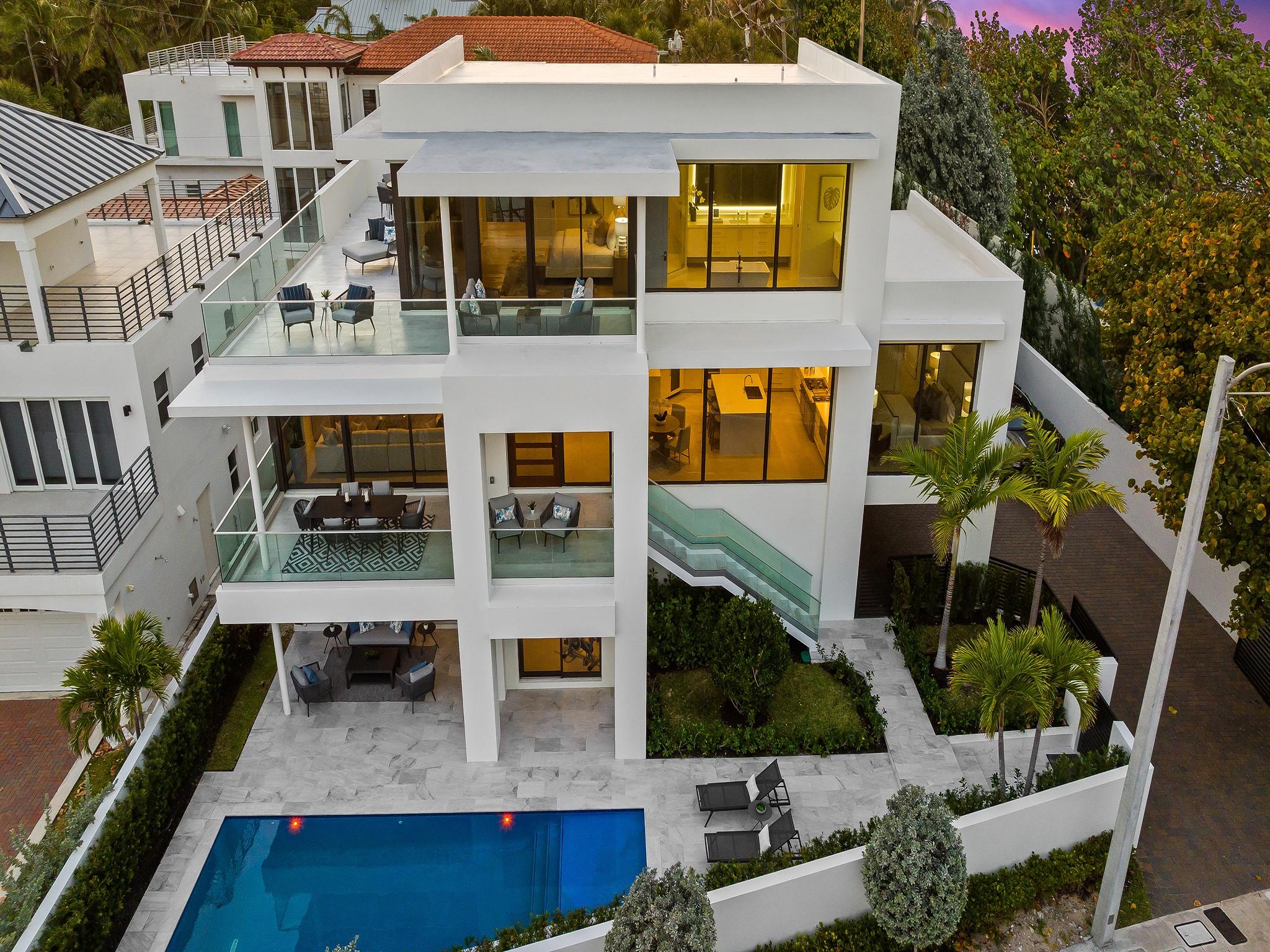 Direct ocean & coastline views from this contemporary masterpiece across from the Atlantic ocean. Inspired by a new level of contemporary luxury & striking architectural design. Life by the sea is enhanced by floor to ceiling walls of glass inviting beachfront front views & natural light over the open concept floor plan. Expansive terraces extend interior living spaces for a year round oasis of tranquility & beauty. The culinary kitchen is ideal for entertaining & overlooks the great rm, dining rm & home office. A floating staircase or elevator ascends to all 3 floors. The primary suite boasts sunrises, coastline views, an expansive terrace, custom walk-in-closet & lavish bathroom. 1st floor club room, pool, patio area & gated/walled compound accommodates 10 vehicles. Sq Ft from developer.