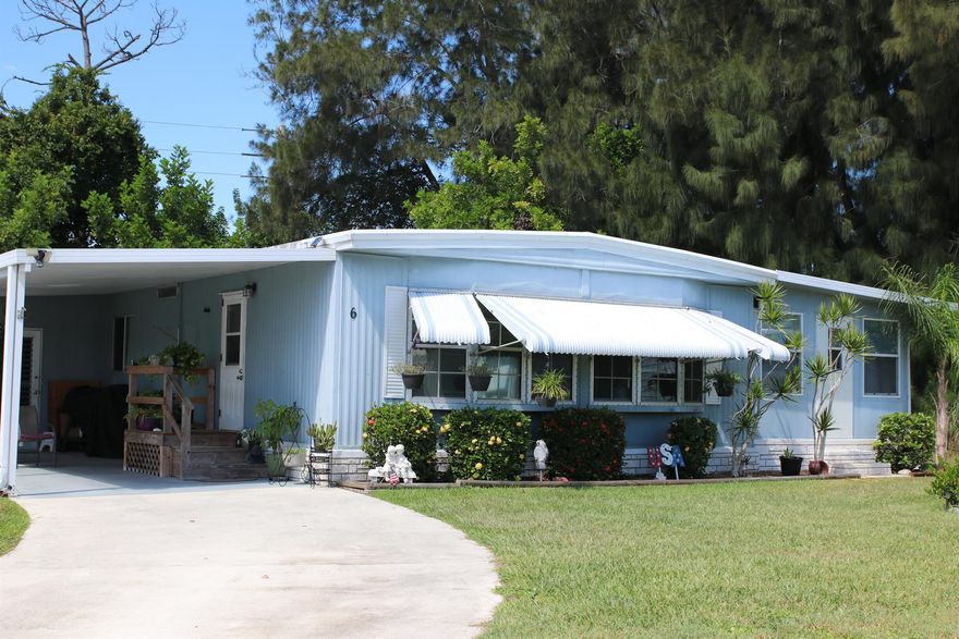 Private Yard Area at this 2 bed/2 bath CulDeSac home. Perfect for Privacy, Pets, Gardening, Barbecues & more! This Outdoor Green Oasis ideal for daytime relaxing or nighttime star gazing. Outdoor Patio offers space to entertain/unwind. Shed provides ample storage. Large Florida Rm serves as extra living room/den/home office. Master bedroom features en-suite bathroom & a spacious closet. AC 2025, Roof 2017 & these Floors are Solid. Very well maintained home w/ just a couple owners. PRIME LOCATION; near beach, grocery stores, post office, banks, hospitals, pharmacy, mall & more! Lot lease 865.27 includes lawn care, trash, free private golf course heated pool, pickleball, tennis, shuffleboard, bocce, gym, library, cards, Mahjong, bible study, wood workshop, dinners, parades, dances & more!