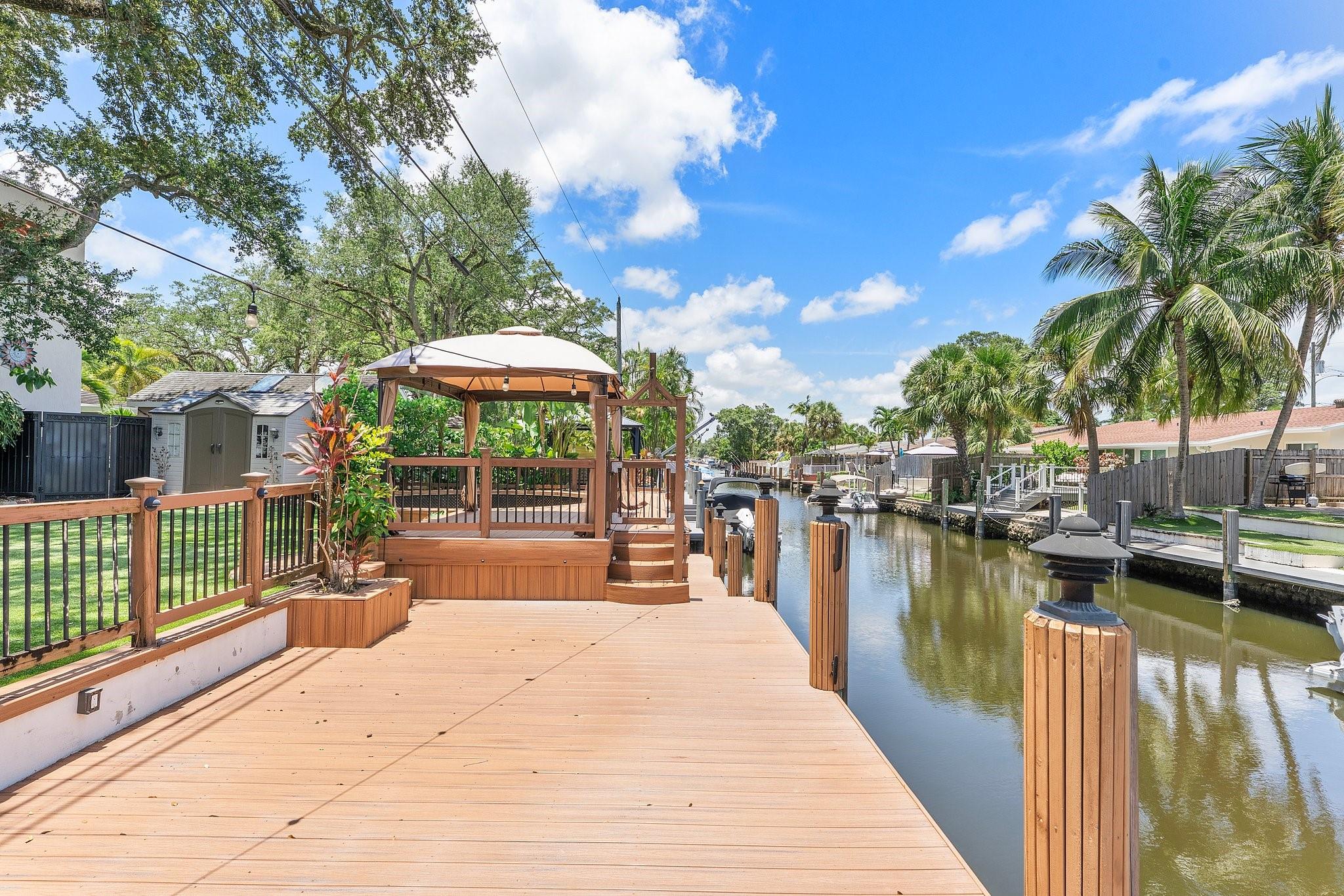 Discover a boater’s paradise with 60 feet of prime ocean-access frontage on the most picturesque street in Citrus Isles. This updated six-bedroom, four-bath home is designed for waterfront living, with expansive windows framing tranquil canal views. Entertain dockside with a waterside pavilion, generous deck, and rooftop perch perfect for sunset cocktails. The residence features soaring ceilings, a cozy fireplace, and oversized porcelain tile throughout. With impact windows and new roofing, this rare retreat offers both peace of mind and effortless access to the open ocean. OPEN Saturday 10/25 & 11/1 from 11-1 pm.