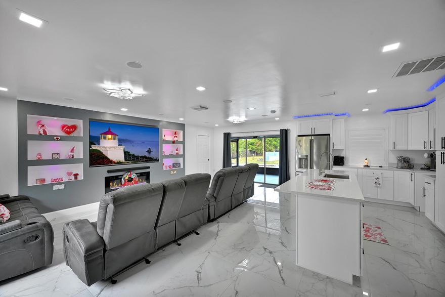 BRING THE WHOLE FAMILY, YOUR TOYS & ANIMALS! This Renovated 3/3 CBS Home is Fully Fenced for Privacy & Situated on 0.97 Acre Lot. Do You Have a Home Business, Require Dissected Space for Multi-Generational Living or Looking for an Income Generating Investment? THIS IS THE PROPERTY! The Detached Auxiliary Unit (Mother in Law) boasts 2 Bedrooms, Bathroom, Living Room & Kitchenette Area(Plumbed w/ Electric). Significant Improvements include a New Septic Tank and Drain field Completed in 2023. The Titan Tankless Water heater, Whole House Generator Hook-Up, New GE Washer & Dryer, Indoor/Outdoor Audio System & Enhanced RGB/LED lighting for Fully Customizable Ambiance Year Round.

The Interior was Extensively renovations in 2024. Both homes features 48" x 24" High Gloss Marble Like Porcelain Tile Flooring, giving a seamless and Modern aesthetic throughout. All bathrooms have been fully renovated with Custom Walk In Showers, 
Nook Inlays, Smart Bidet Toilets, Modern Vanities w/ Vessel Sinks &  Illuminating Fixtures delivering a Spa-like Experience.

The Brand-New Kitchen was completed in February 2026, featuring Quartz Counters & Backsplash, Stainless Steel Appliances & Wood Soft Close Cabinetry with Custom Uplighting.

Enjoy a Movie Night at Home! The Built-in Entertainment Center delivers Movie Theater Quality Audio w/ Enhanced LED Lighting for fully customizable ambiance while the Electric fireplace anchors the Main Living Space. 

Outdoor living is truly one of a kind, featuring an Outdoor Kitchen, Custom Built-in bench with fireplace for entertaining, Dedicated Outdoor Cabana bathroom, Fully Upgraded Pool System w/ a New Pump, House Filtration System, RGB Pool Lighting, RV Hook Up & Full Surveillance Camera System. 

This Unique property has Ample Space for ALL Your Small Animals, Over 45 grafted tropical Fruit Trees, creating a lush & Productive landscape unlike anything else on the market.

This home offers a rare combination of Modern technology, extensive renovations, privacy, and exceptional outdoor livingideal for families, entertaining, or multi-generational living. A truly one-of-a-kind propertyschedule your private showing today.