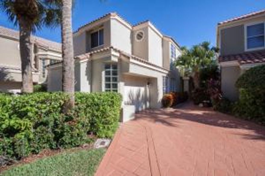 PRICE REDUCED $40,000!!! Pristine East Boca home in gated country club with NO MANDATORY MEMBERSHIP!This light-filled 3B/2.5B  boasts 2 spacious living areas, a powder room & a private master suite with luxurious, updated bath on the lower level.  As you enter, you are greeted with lofty 20+ ft volume ceilings in the sun-filled, open living room featuring 18” tile flooring.  Opening to the living areas is the kitchen with wood cabinetry, sleek granite counters, and new stainless steel dishwasher, perfect for entertaining family and friends. Through the sliding glass doors, step out onto your private patio & fenced lawn to enjoy inviting sunrises in the morning or coastal breezes in the evening. The master retreat also opening onto the patio, is spacious and offers an oversized closet, rich wood cabinetry, granite counters with 2 separate vanities, garden tub and extra large shower! 
On the upper level is a cozy loft, with open views from the clerestory windows, a perfect place to curl up with a book or to have a home office!  Also, on the upper level are 2 more bedrooms and a totally renovated full bath. With 1 car garage, this home is truly a choice residence in Boca Country Club, a neighborhood centrally located with walking paths, tree-lined boulevards and optional membership at the Club. Newer appliances include A/C (2011), washer & dryer (2011), dishwasher (2013). Several windows and a slider have been installed with impact glass.