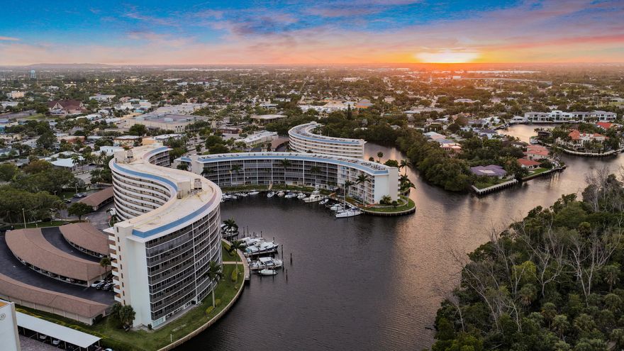 One of the finest three-bedroom waterfront residences in Hillsboro Cove, offering unparalleled views of the river & Capone Island. Meticulously remodeled, this condo features Azul Macaubus quartzite counters in the chef's kitchen, top-of-the-line KitchenAid appliances, & LED high hat lighting. custom translucent barn doors lead into each bedroom. The master bath features an 80-inch vanity, a bidet with multi heads in the oversized shower. The guest bath boasts a luxurious soaking tub overlooking the river with a view of the mega yachts as they go by. A Dimplex custom-built light & steam fireplace wrapped in quartzite adds a warm elegance. Just a short distance to local dining in Deerfield Beach & Boca Mizner a 5-min drive. This residence epitomizes luxury living. Boat slips. CONCRETE PAID!