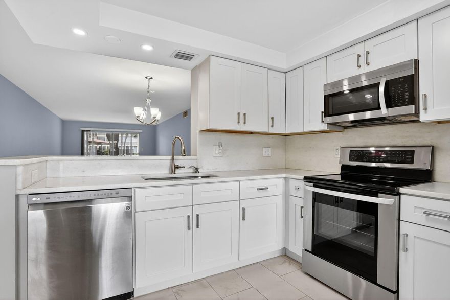 1ST FLOOR FULLY RENOVATED 2/2 CONDO, OPEN CONCEPT KITCHEN WITH CUSTOM WHITE SHAKER STYLE CABINETS, SS APPLIANCES & QUARTZ COUNTERS. PORECELAIN TILES THROUGHOUT MAIN AREAS AND VYNIL WATERPROOF LAMINATE IN BEDROOMS. BATHROOMS ARE EQUALLY CHIC, W/ WALK-IN SHOWERS & UPSCALE VANITIES. HURRICANE IMPACT WINDOWS & FRONT DOOR. LG FRONT LOADER WASHER/DRYER IN UNIT! WALK-IN CLOSETS, GARDEN AND POOL VIEWS FROM IMPACT WINDOWS ENCLOSED PATIO. WYNMOOR HAS A VIBRANT SOCIAL SCENE W/ACTIVE CLUBHOUSE OFFERING CLUBS AND CLASSES GALORE! PICKLEBALL, TENNIS, THEATER, BILLIARDS, FITNESS CENTER AND MUCH MORE! 18 HOLE EXECUTIVE GOLF COURSE, FREE SHUTTLE BUS INSIDE & OUT OF THE COMMUNITY. WYNMOOR IS A GATED COMMMUNITY W/24HR SECURITY. MEET NEW FRIENDS AND ENJOY THE TROPICAL PARADISE OF WYNMOOR!