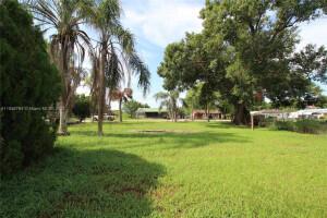 LAKE OKEECHOBEE ACCESS - Improved lot with trees and a pad. There used to be a mobile home on property. There is septic, water, and power.