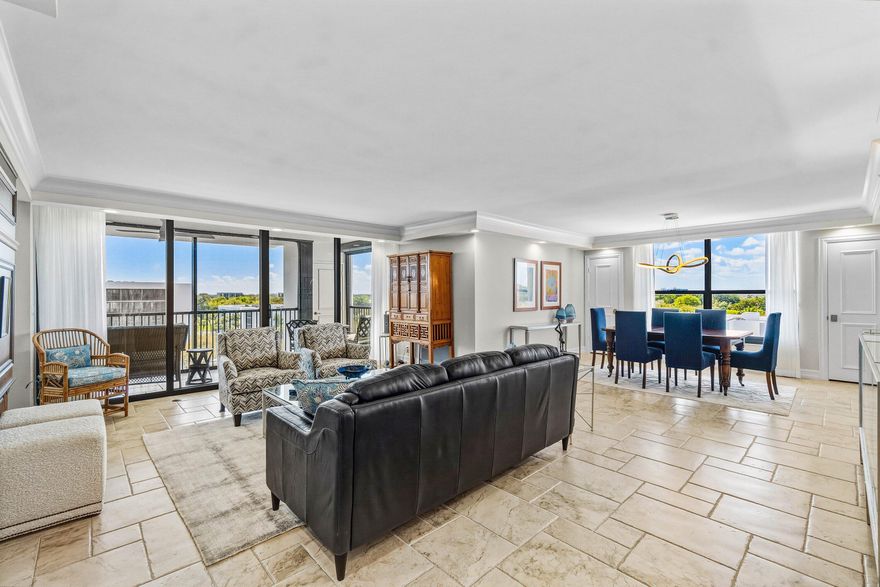 This beautifully renovated 3-bedroom, 2.5 bath top-floor condo has been updated with the finest materials and thoughtful design throughout. The home is light and bright, featuring tile flooring in the living areas and custom wood built-ins.  The kitchen offers quartz countertops, a stone backsplash, and stainless steel appliances. The third bedroom has been opened to the living area to create additional space, though the wall can easily be replaced if a separate bedroom is desired. Additional highlights include extra closets in the primary bedroom and dining area, plus a large custom pantry.  All sliding glass doors and windows are impact-resistant, and the patio also has additional hurricane shutters, allowing outdoor furniture to remain in place during storms.