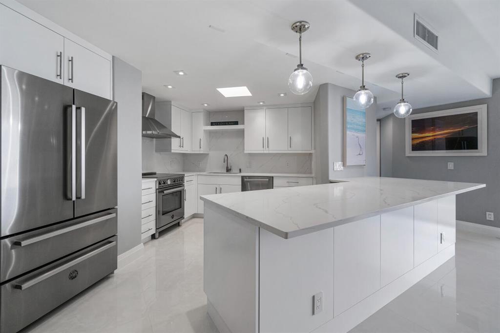 Exceptional opportunity to make a completely remodeled and exquisitely re-imagined Penthouse unit yours! This 2 bedroom and 2 bath condo in South Palm Beach's oceanfront condominium building, Dune Deck, has been entirely reconstructed. Not a single element of this unit is original as it boasts Italian tile throughout the entirety of the space, a brand new kitchen re-designed to encompass an open concept lifestyle with high end stainless steel appliances. Brand new HVAC system with new duct work allowing for heightened ceilings illuminated by recessed LED's. Both bathrooms are marvelously crafted with floor to ceiling tile exuding spa like features including natural light from the sky lights. The greatest aspect of this remarkable renovated penthouse is the western exposure