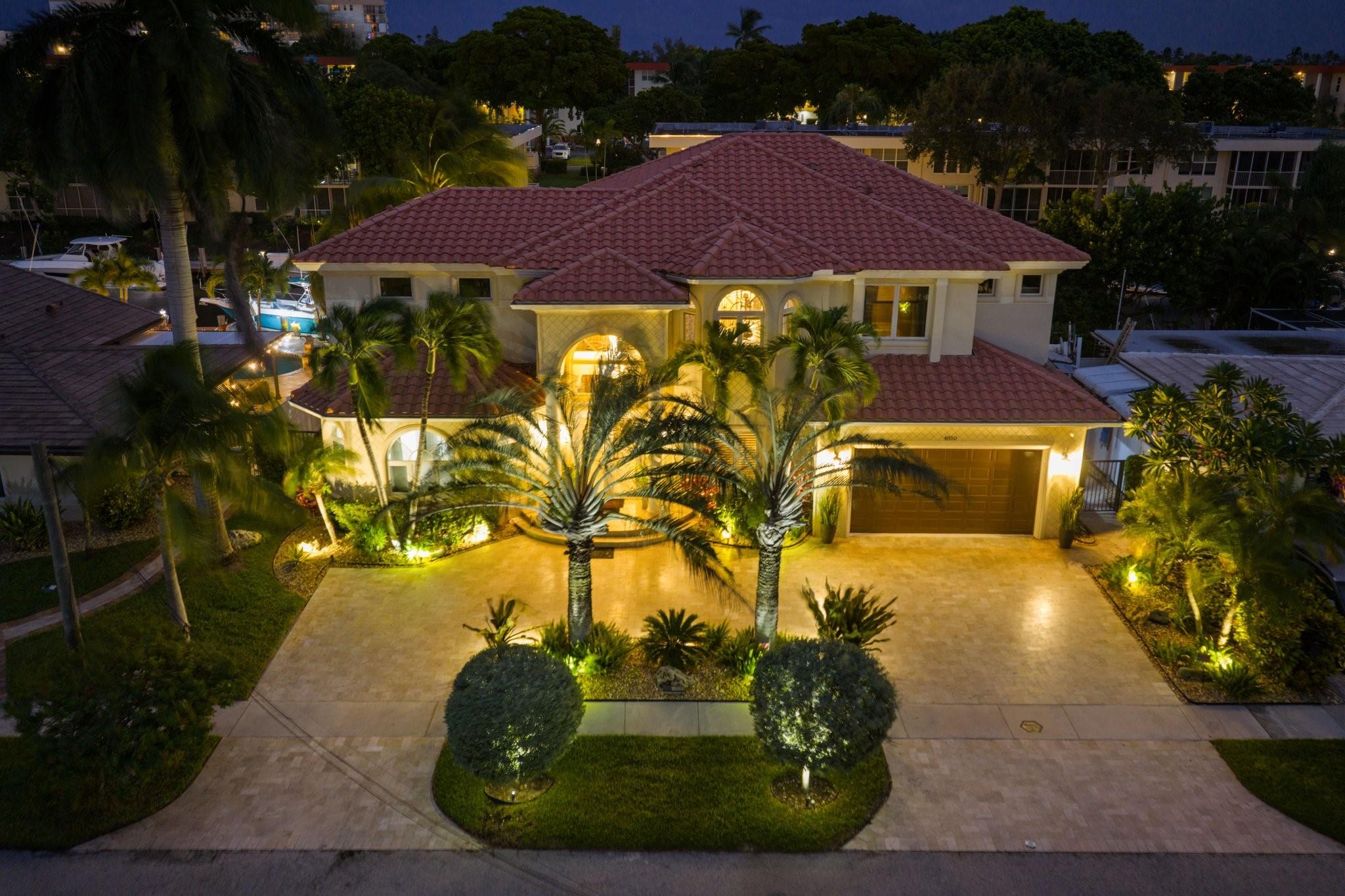 Luxurious Custom-built Intracoastal Estate in Lighthouse Point. Enjoy 80-ft private dock with full ocean access, No Fixed Bridges. This elegant 5-bedroom, 4.5-bath residence is crafted for upscale waterfront living. Impressive foyer with soaring volume ceilings, marble floors & impact windows. First floor features a Spacious Master Suite w/panoramic pool & waterfront views. Gourmet kitchen with granite countertops, stainless steel appliances & gas range. Upstairs, four spacious bedrooms, refined updated baths & large den with wood flooring. Two laundry rooms. Outdoor features  heated pool with spa, built-in outdoor kitchen & cabana. Custom garage built for functionality with lift and storage. Stunning landscaping, new A/C units, pool heater & much more.