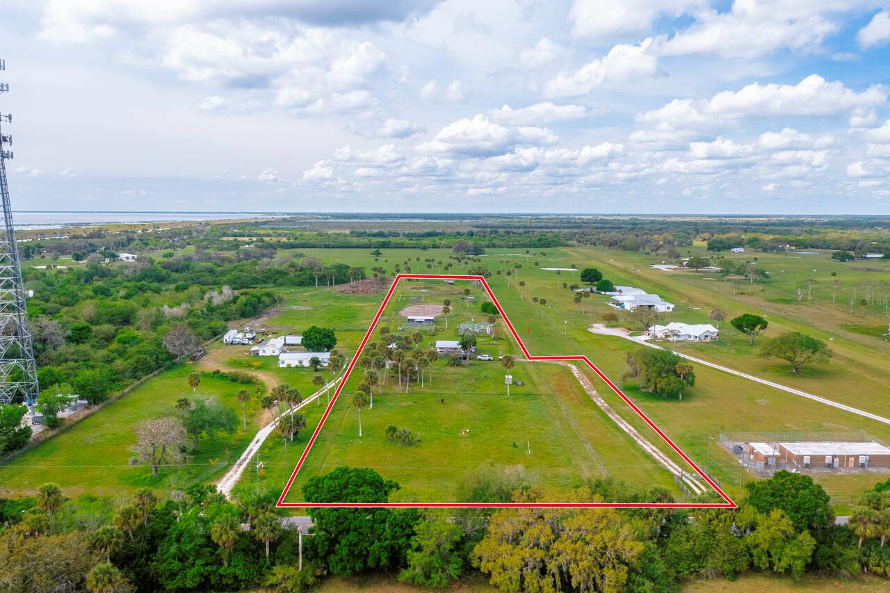 Discover serenity on this stunning 7.53-acre parcel in Okeechobee, nestled near the exclusive Flying Cow Air Ranch Airport. Included is a 3/2 manufactured home, though in need of significant renovation, this property is priced for its exceptional land value. Unleash the potential of this picturesque space and create your own oasis in the heart of nature.