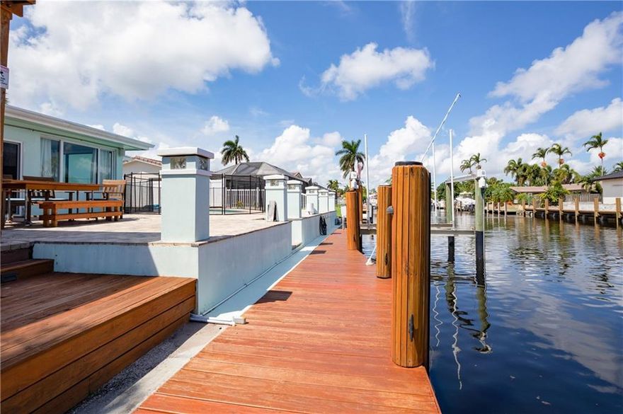 Boasting an array of new upgrades and a thoughtful open plan layout, this immaculate 3-bedroom, 2-bathroom canal front home is perfect for those looking for a home that has it all. Features of this 1,836 sq. ft. home include a new boatlift, pool, relaxing outdoor patio space with eastern exposure, new upgraded AC, impact windows and doors, plenty of storage space along with a new seawall. The home flows into a luminous, open-concept living, dining, and kitchen area. The open kitchen is equipped with modern lighting and a suite of stainless steel appliances all with new vinyl flooring throughout the home. The bedrooms sit just off the living areas.  Two car garage, great for storage.  The home is situated just off Atlantic Ave with easy access to the beach and other local attractions.