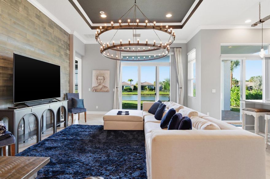 Welcome to 18024 SW Cosenza Way, an elegant and meticulously maintained home located inside the highly desirable PGA Village Verano community. This residence offers peaceful water views, a modern open layout, and a lifestyle centered around comfort, connection, and resort-style living.Inside, you'll find a bright, inviting floor-plan with a spacious kitchen and oversized island that flows seamlessly into the dining and living areas, perfect for everyday living or hosting friends and family. Large sliding doors frame the tranquil water view behind the home, filling the space with natural light and creating an effortless indoor and outdoor feel.