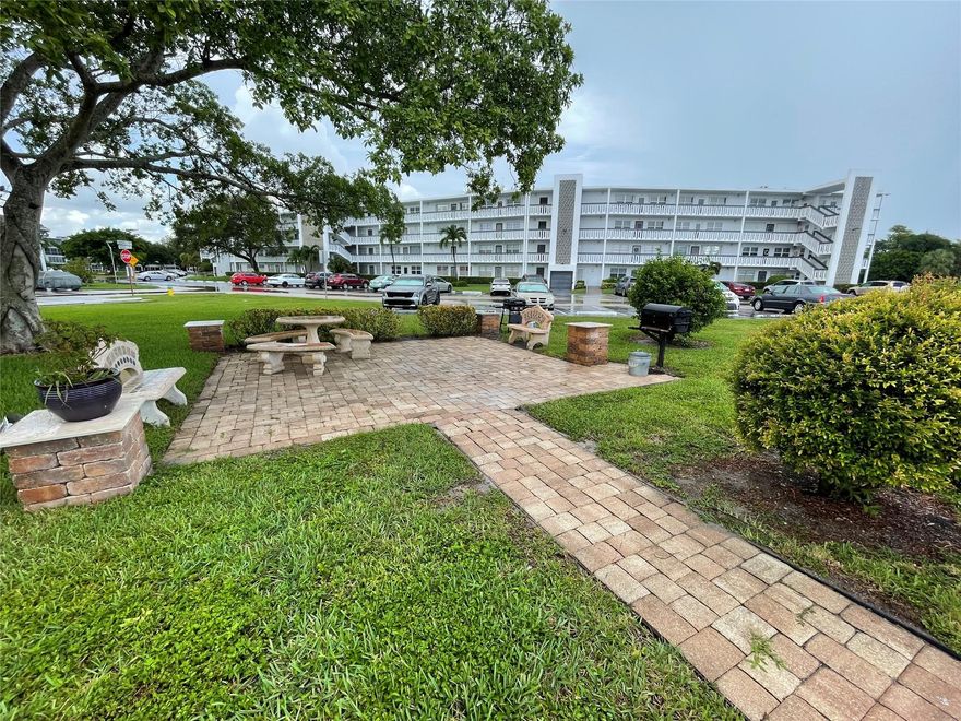 Lovely 1 bedroom, 1 bath, 2nd floor condo in Garden Style Building. Located in active adult community in the heart of Deerfield Beach. Paved BBQ area in front of building for get togethers!  NEW ROOF - MAY 2025!  Open kitchen, large ceramic tile through out. Newer A/C wall unit, HWH 2 years old. Beautiful French Doors in bedroom! CVE offers resort style amenities galore including a lavish clubhouse, 1,500 seat theater, premier performances, shuttle buses, state of the art gym, pickleball, putting greens, tennis, indoor & outdoor pools, movies, classes of every type & more! Close to shopping, restaurants & beach. Assoc. claims 55+.