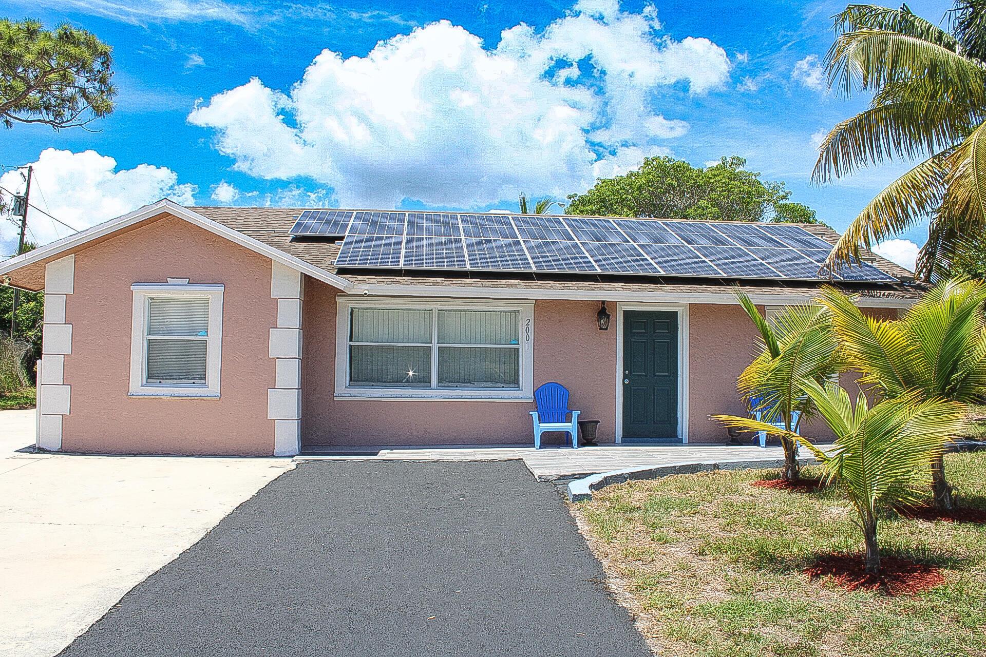 Welcome, this home is freshly renovated and move-in ready! This stunning property features new appliances, floors, baths, kitchen and much more. The solar panels will provide huge FPL savings to your power bill. Nestled on a huge half-acre lot with tropical grounds and over 40 coconut and fruit trees. NO HOA, completely fenced yard with secure parking for over 10 cars. This home offers the ultimate freedom! Whether you want to park your RV, build a pool, or even extend the home, the possibilities are endless. Storage located in the backyard could also be turned into an efficiency. Don't miss out on this rare​​‌​​​​‌​‌​​​‌‌​​​‌‌‌​​‌​​‌‌​​​​ opportunity.